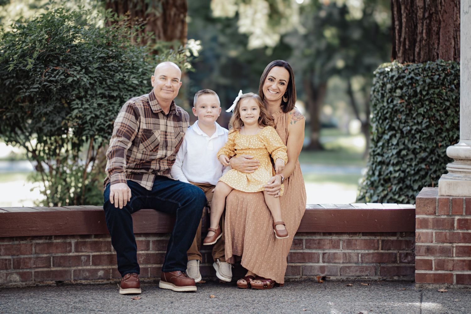 Candid family portrait at UOP in Stockton, CA with fall colors and gentle posing during October 17th mini sessions.