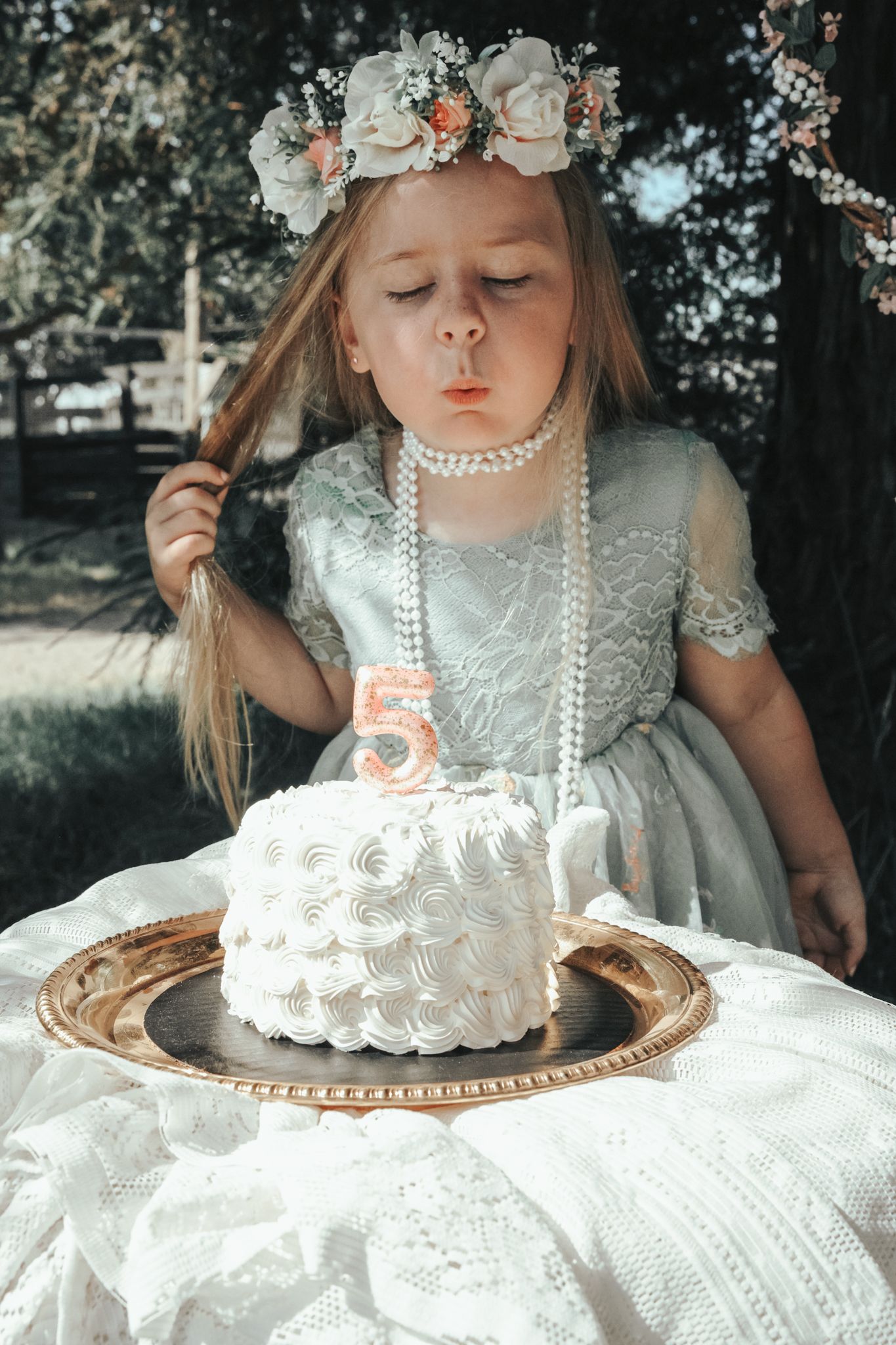 A sweet birthday milestone moment captured at West 12 Ranch Studio in Lodi, CA. The little one sits beside a simple birthday cake, surrounde