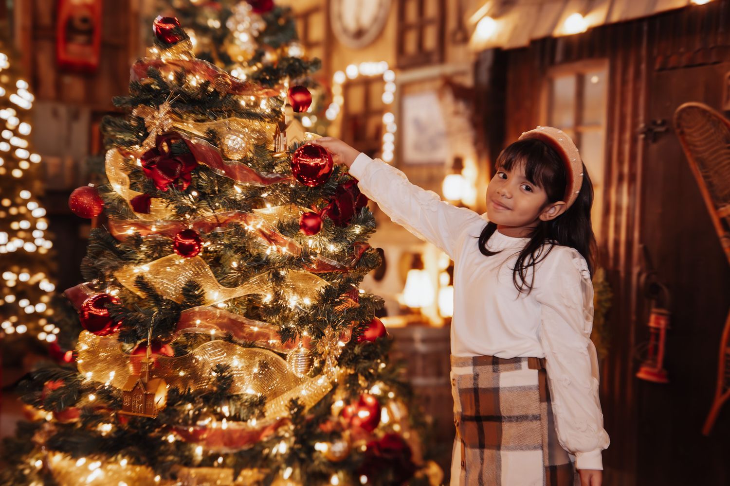 A series of warm holiday scenes showing decorated Christmas trees and festive indoor lighting at a cozy gathering.