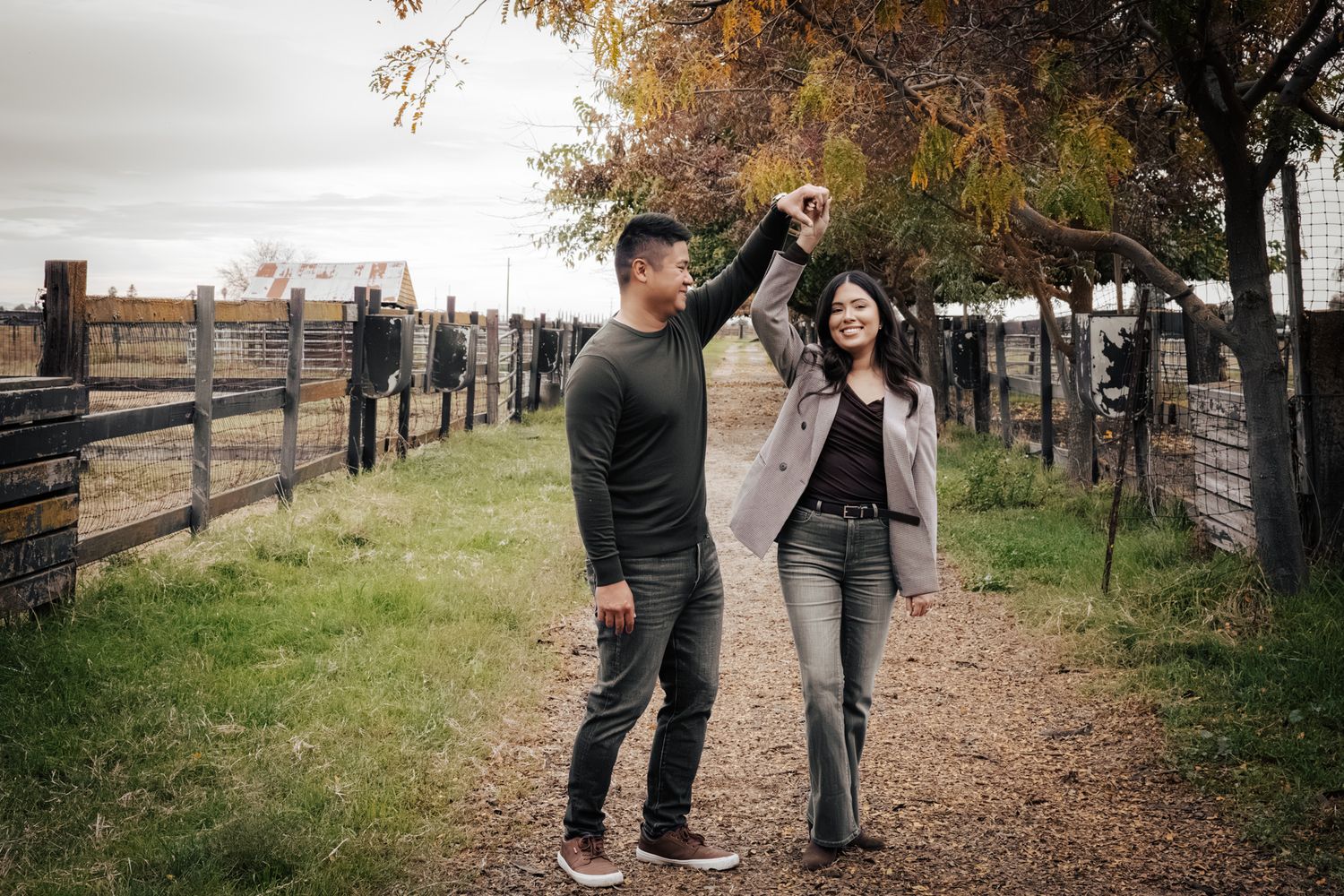 Rustic fall couple’s portrait session outdoors with warm natural‑light tones.