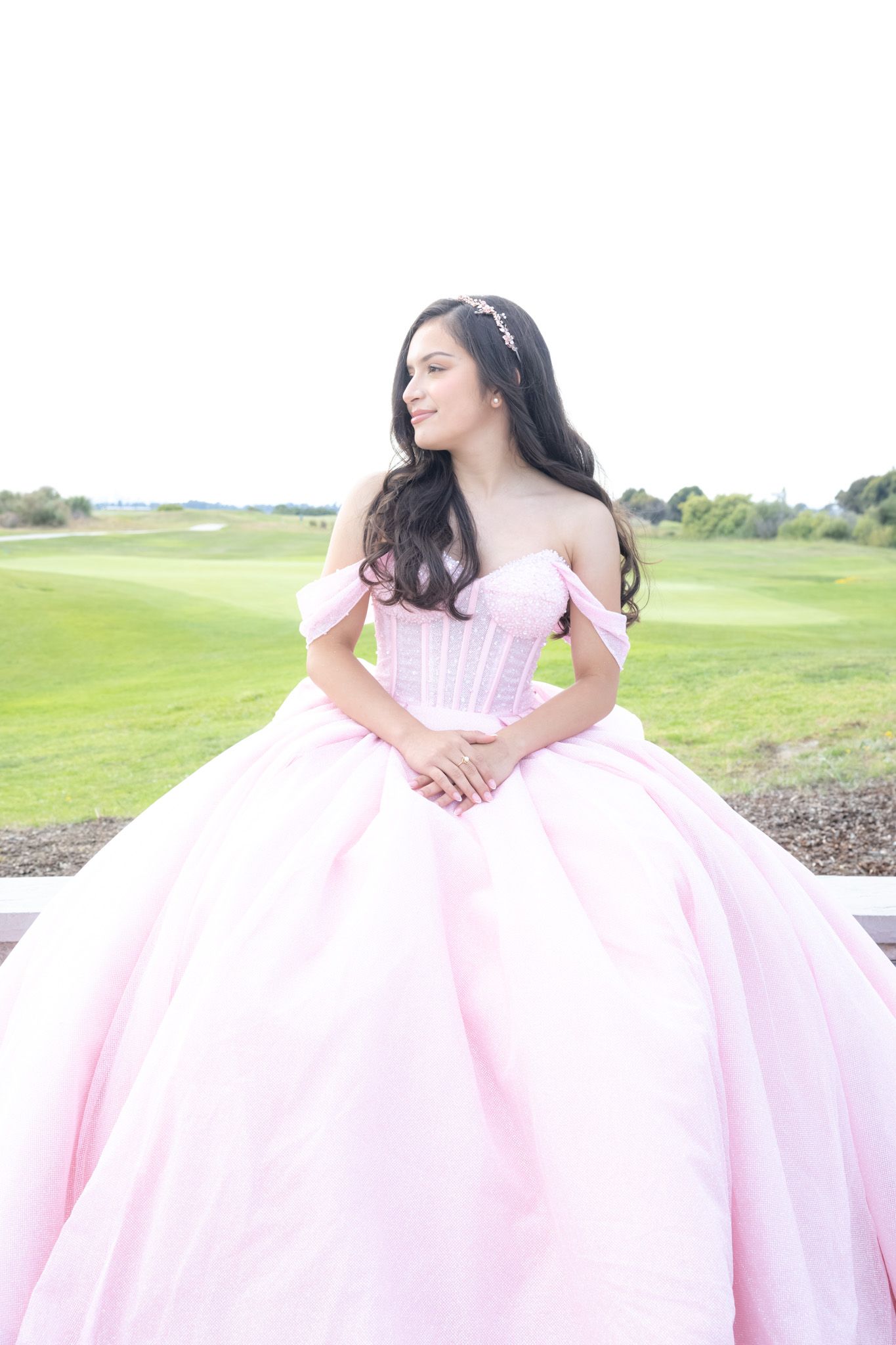 Outdoor self‑portrait of the photographer in bright natural light at the Oakland, CA quinceañera venue before the event.