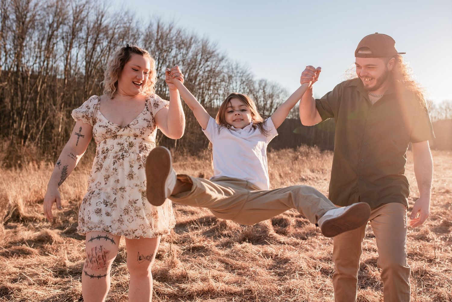 Family run and play in field at golden hour in connection focused photo session with R&J Photography in Summit Hill PA
