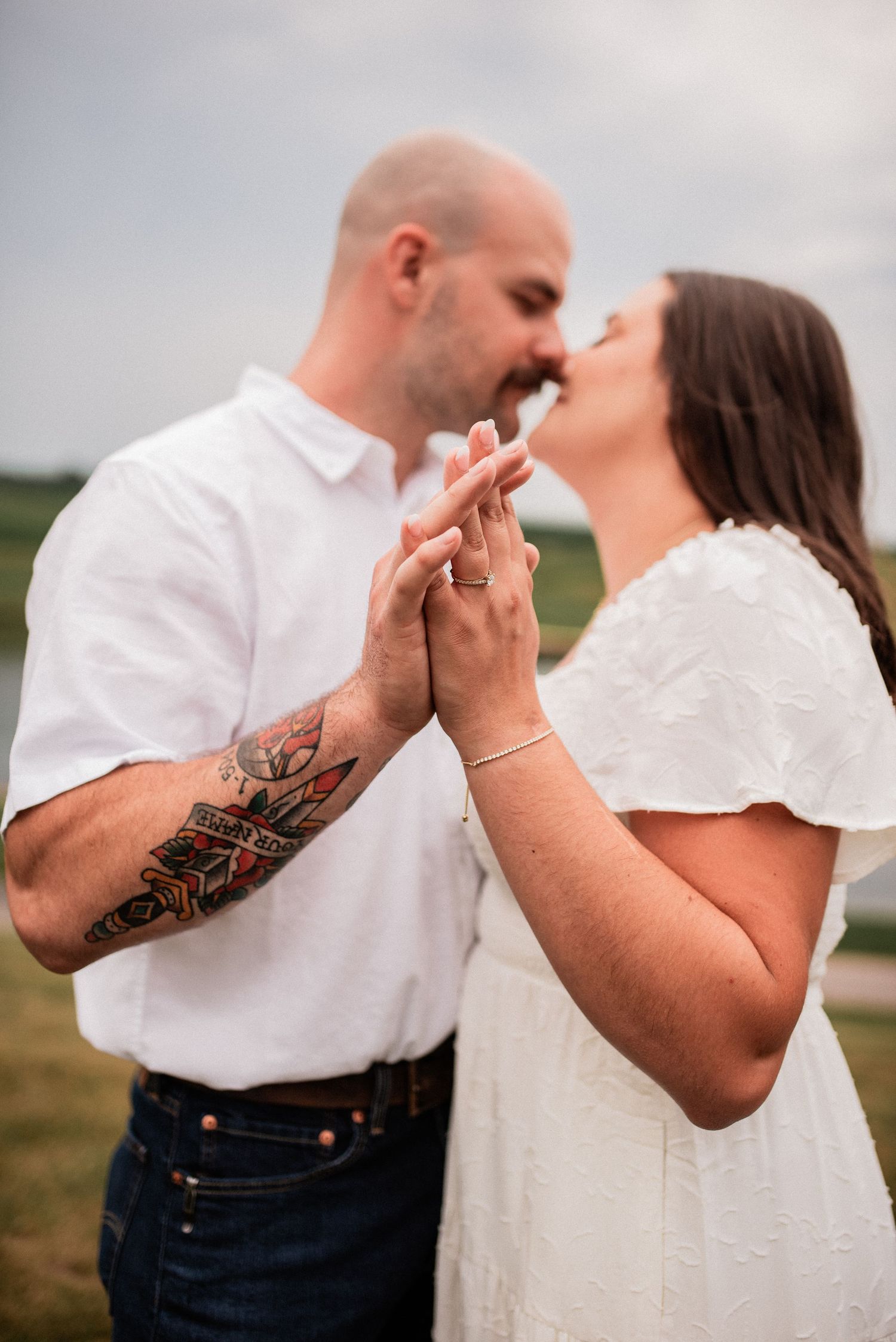 Couple snuggle and hold each other while celebrating engagement with engagement photos in New Tripoli Pennsylvania with R&J Photography