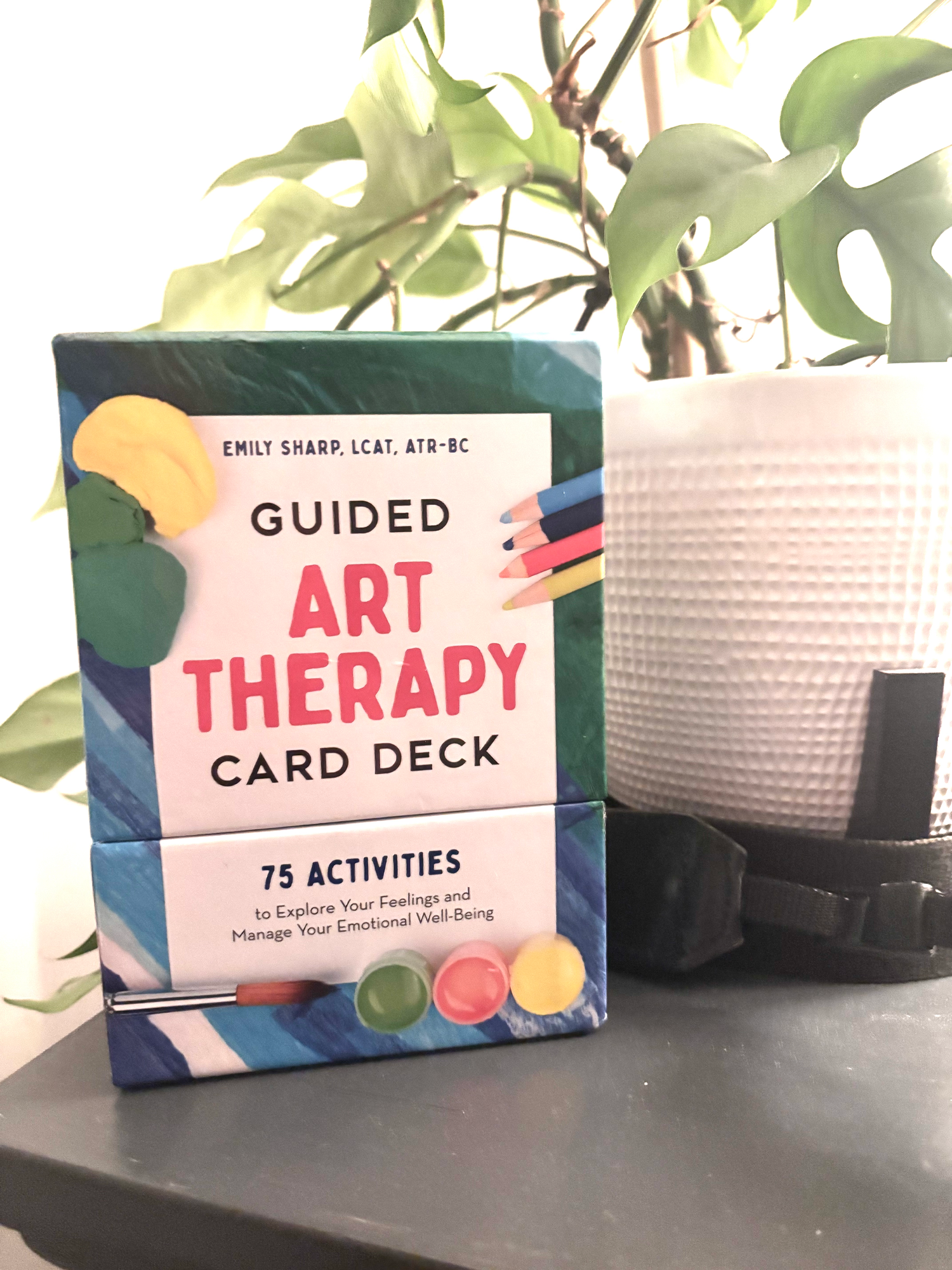 Guided Art Therapy Card Deck by Emily Sharp with 75 activities on shelf.