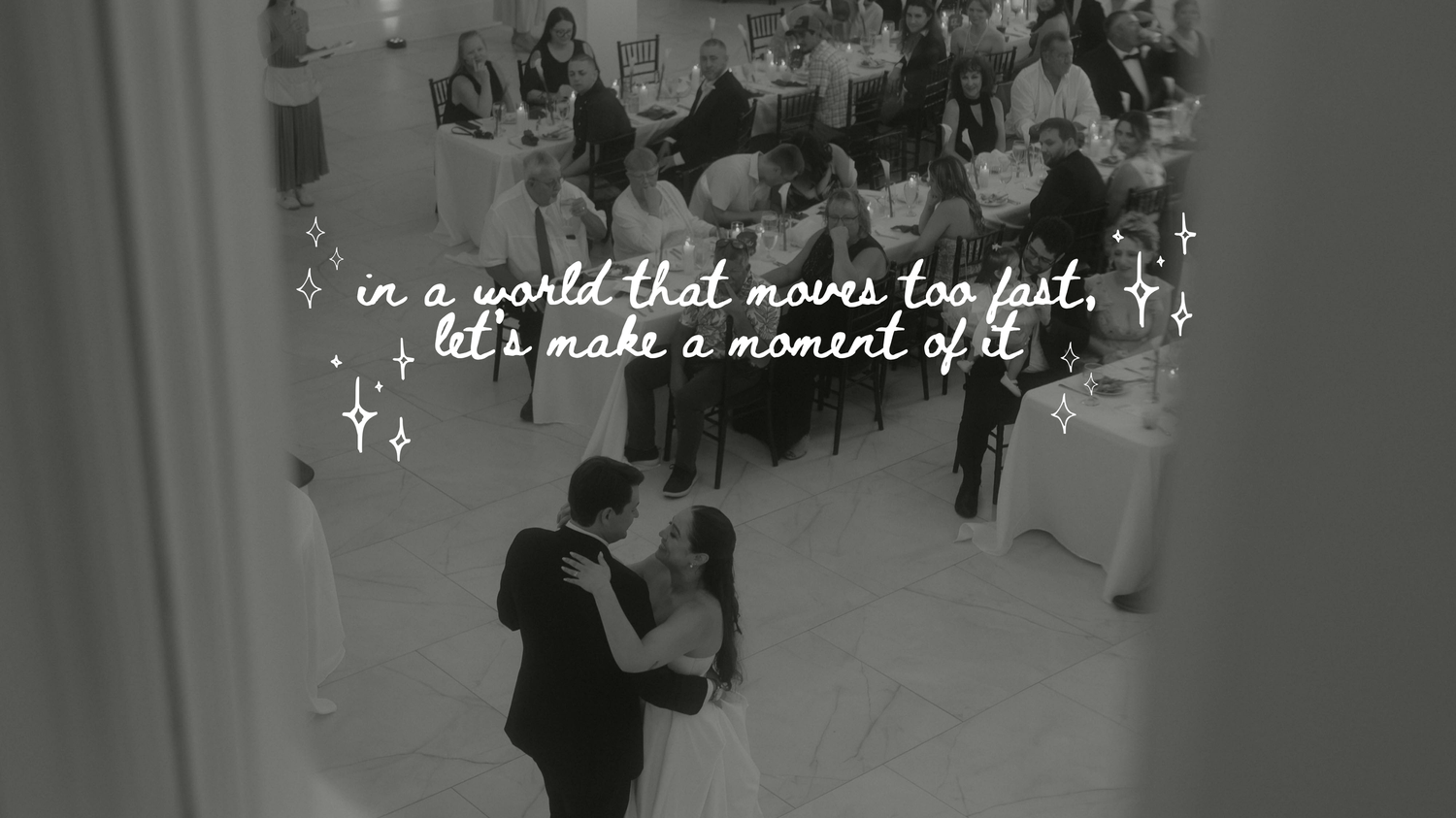 Black-and-white photo of a couple sharing a slow dance at a wedding reception with guests watching and the text 'let's make a moment of it'.