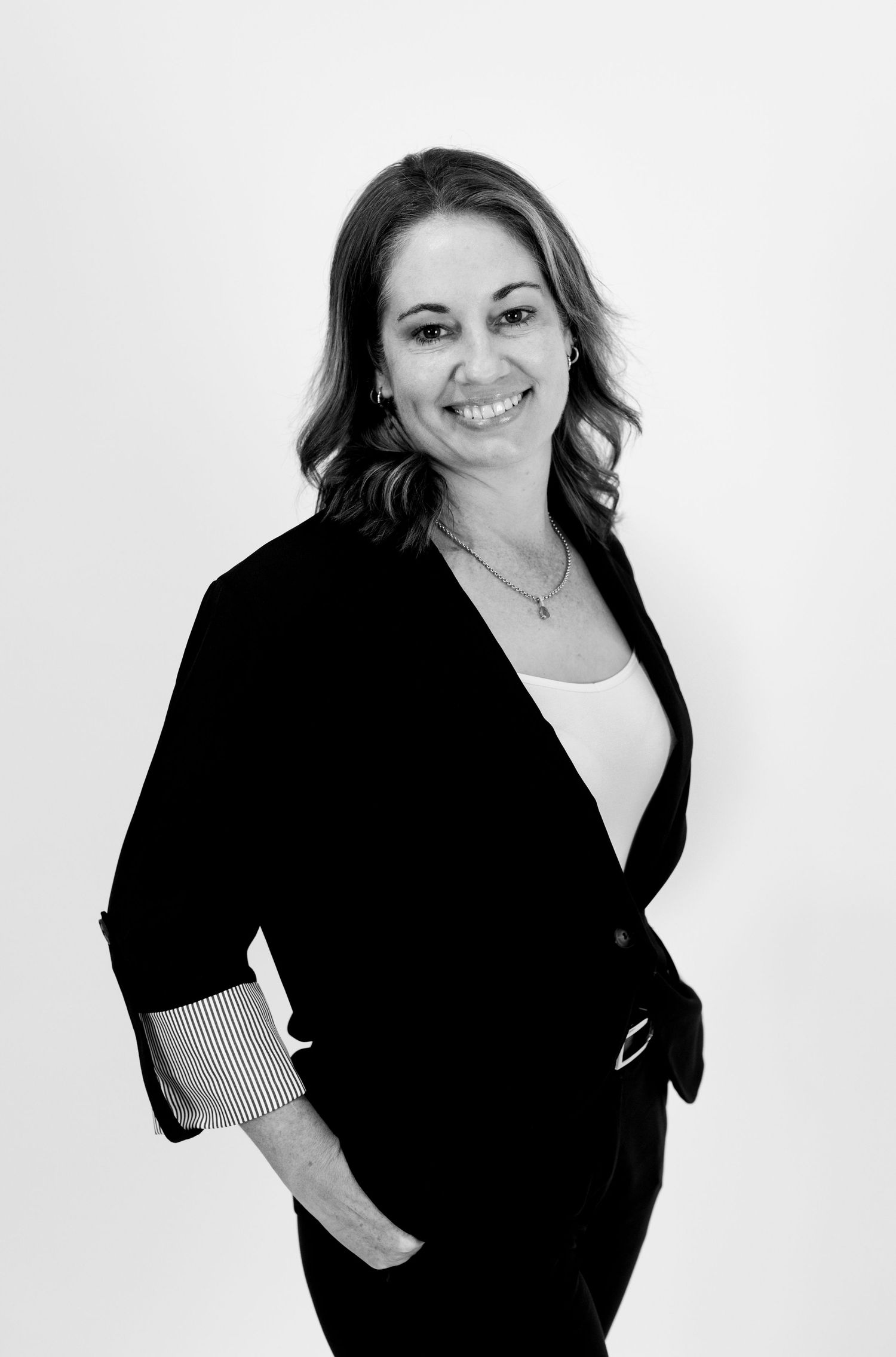 Black and white professional photoshoot featuring casual poses in dark attire.