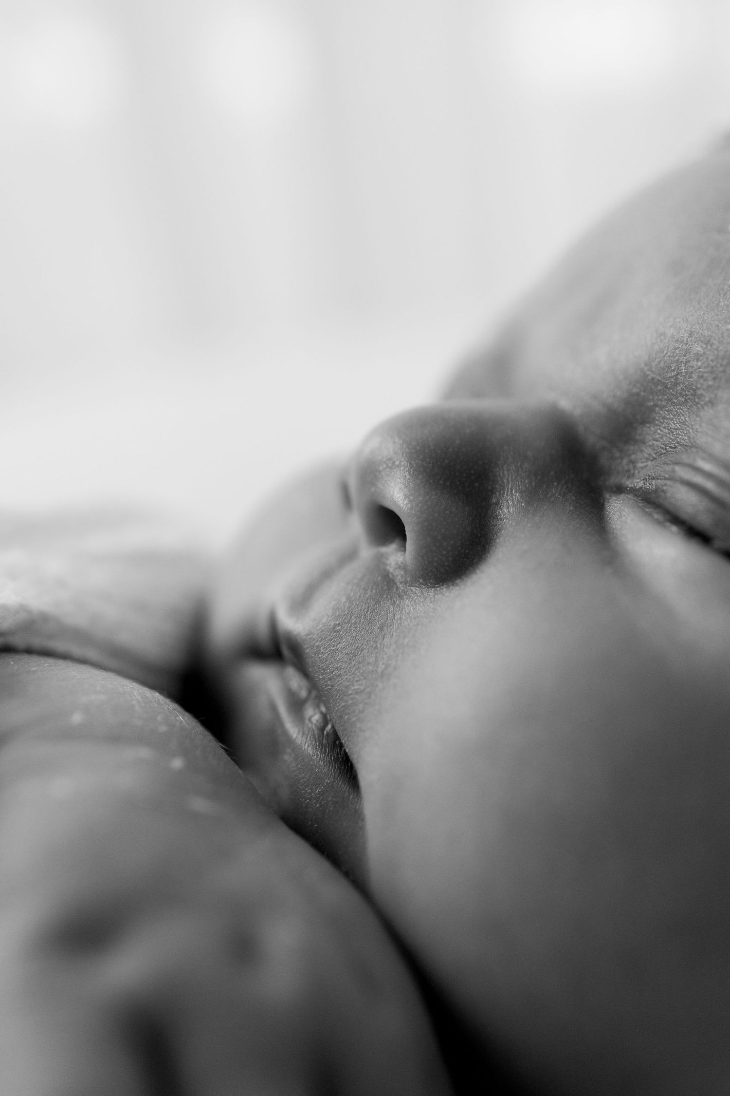 Artistic black and white macro photography of facial features in soft focus.