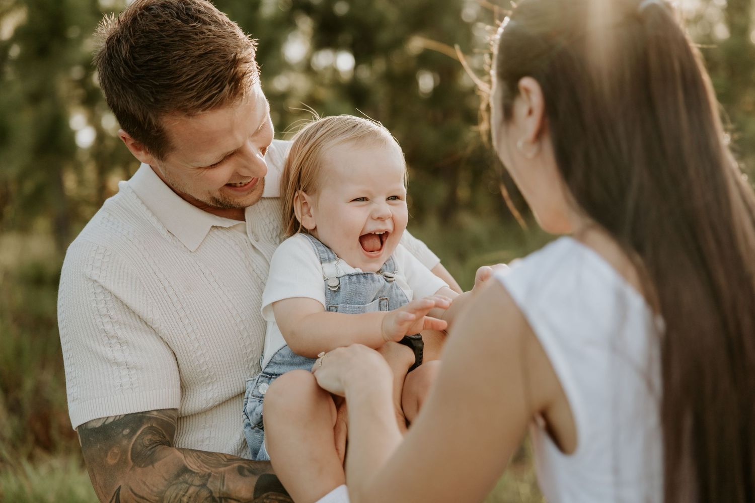 Family sharing joyful moments together outdoors during golden hour.