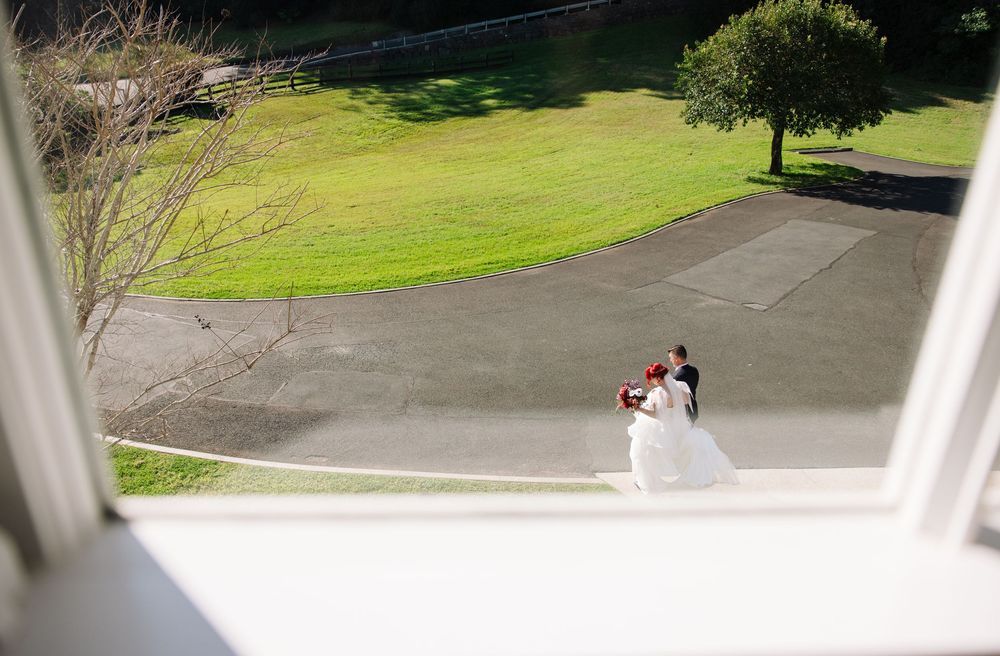 Aerial view of a couple embracing on a sunny outdoor patio.