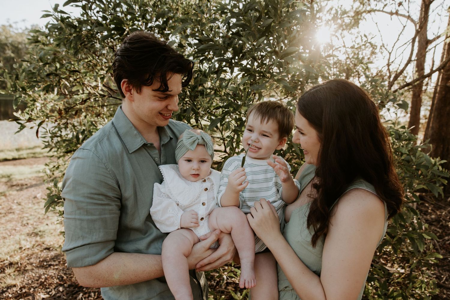 Candid family moments captured in a natural outdoor setting during golden hour.