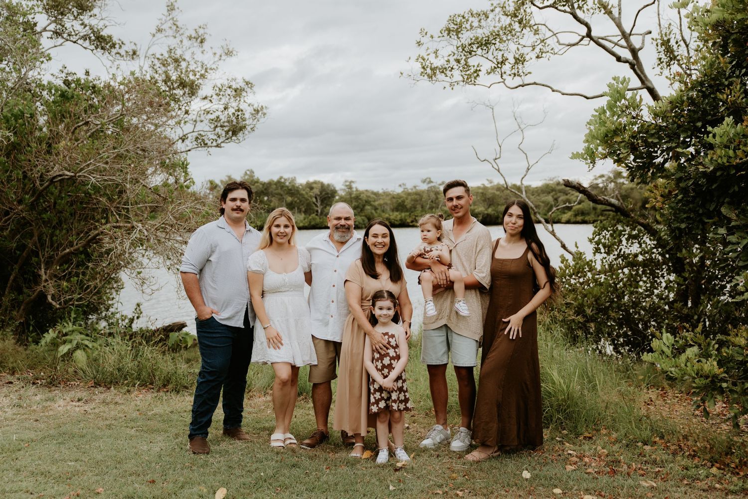 Extended family gathering for group photos in a scenic outdoor setting.