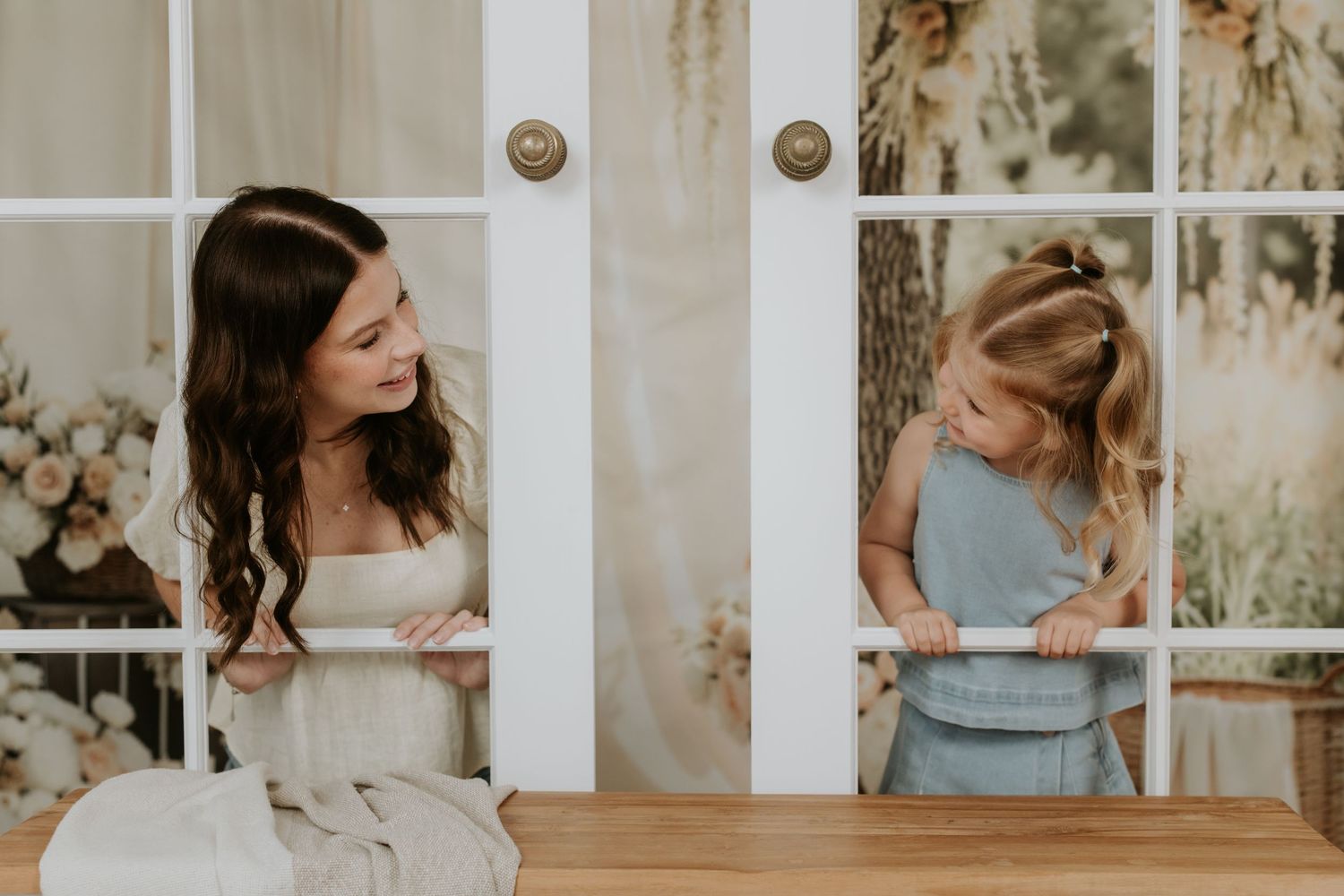 Playful moment shared through window panes in a rustic setting.