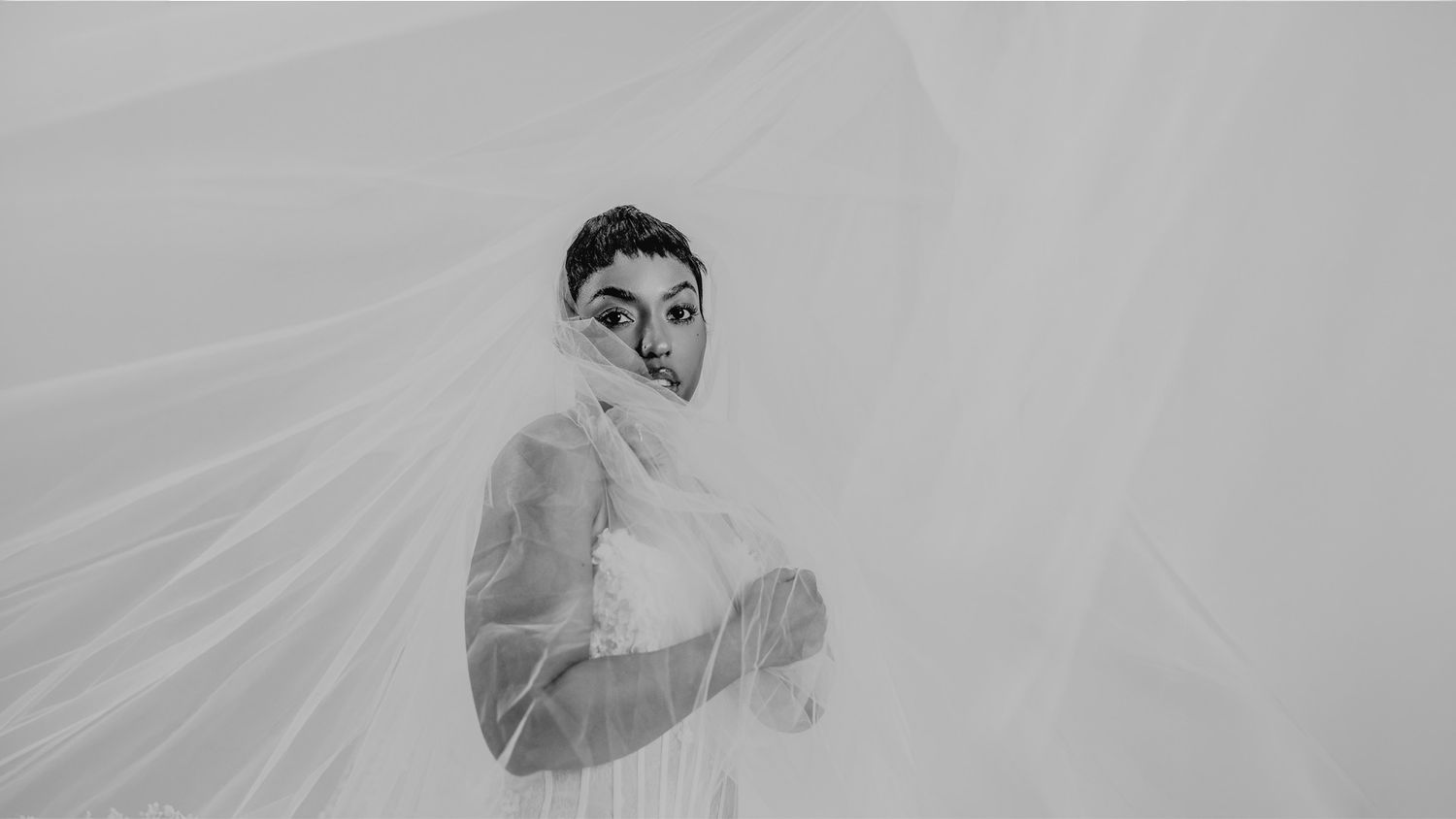 Artistic black and white family photoshoot with dynamic poses.