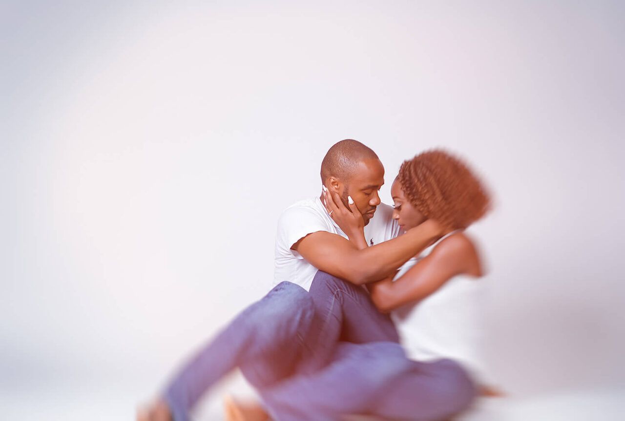Romantic couple photoshoot with soft lighting and intimate poses.