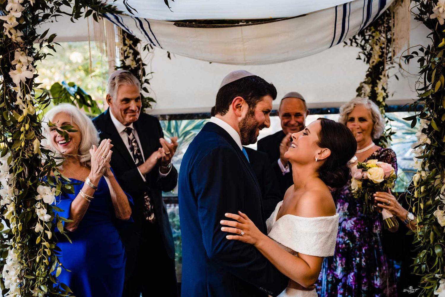 Wedding ceremony moments captured under floral arch decorations outdoors.