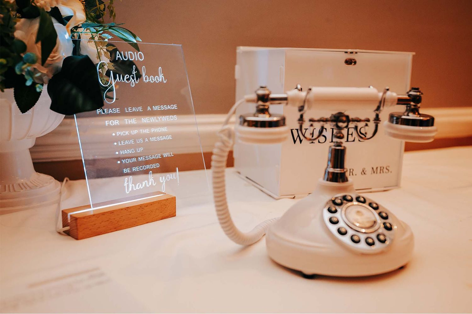 Vintage-style rotary phones and decor elements arranged on a table at a wedding reception.