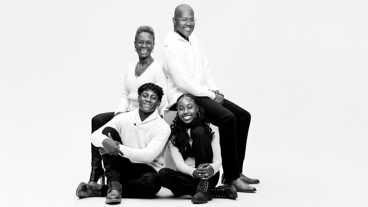 Black and white family portrait series showing joyful interactions.