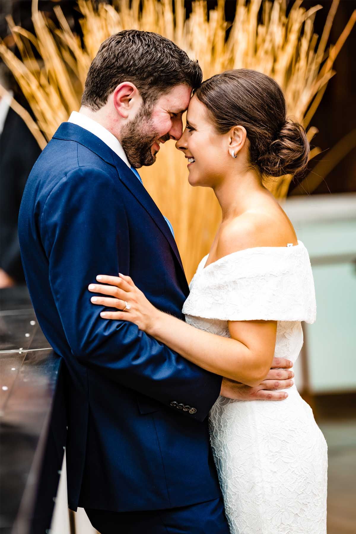 A romantic moment between newlyweds with a golden backdrop.