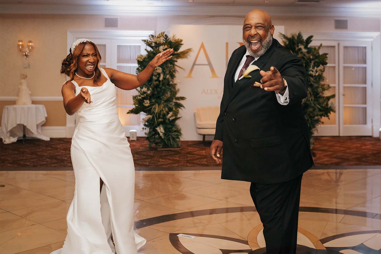 Wedding celebration with elegant decor and dancing in a beautifully lit ballroom.