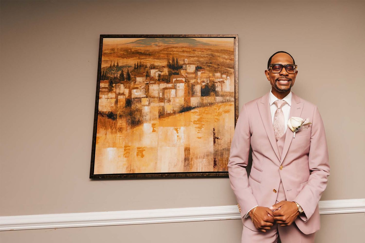 Interior wedding venue shots with abstract art and pink formal attire.