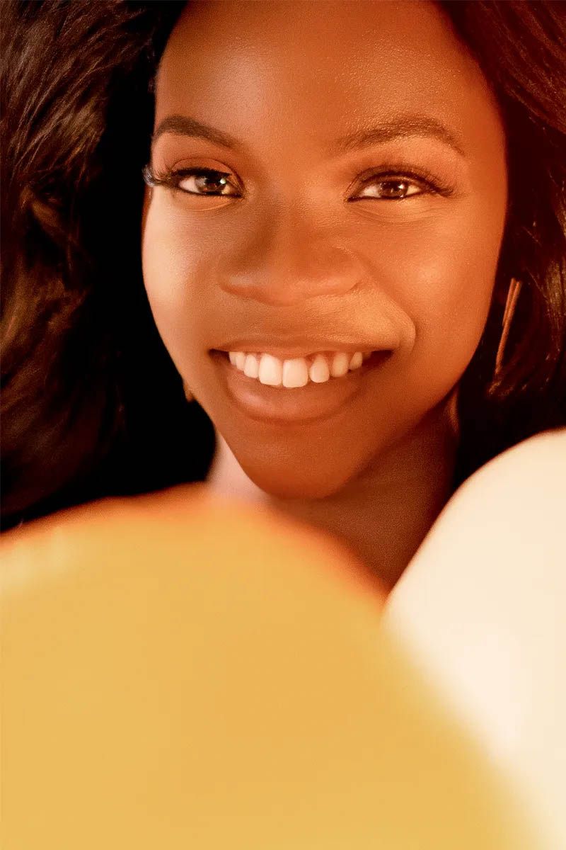 Warm-toned closeup portrait with soft lighting and yellow accents.