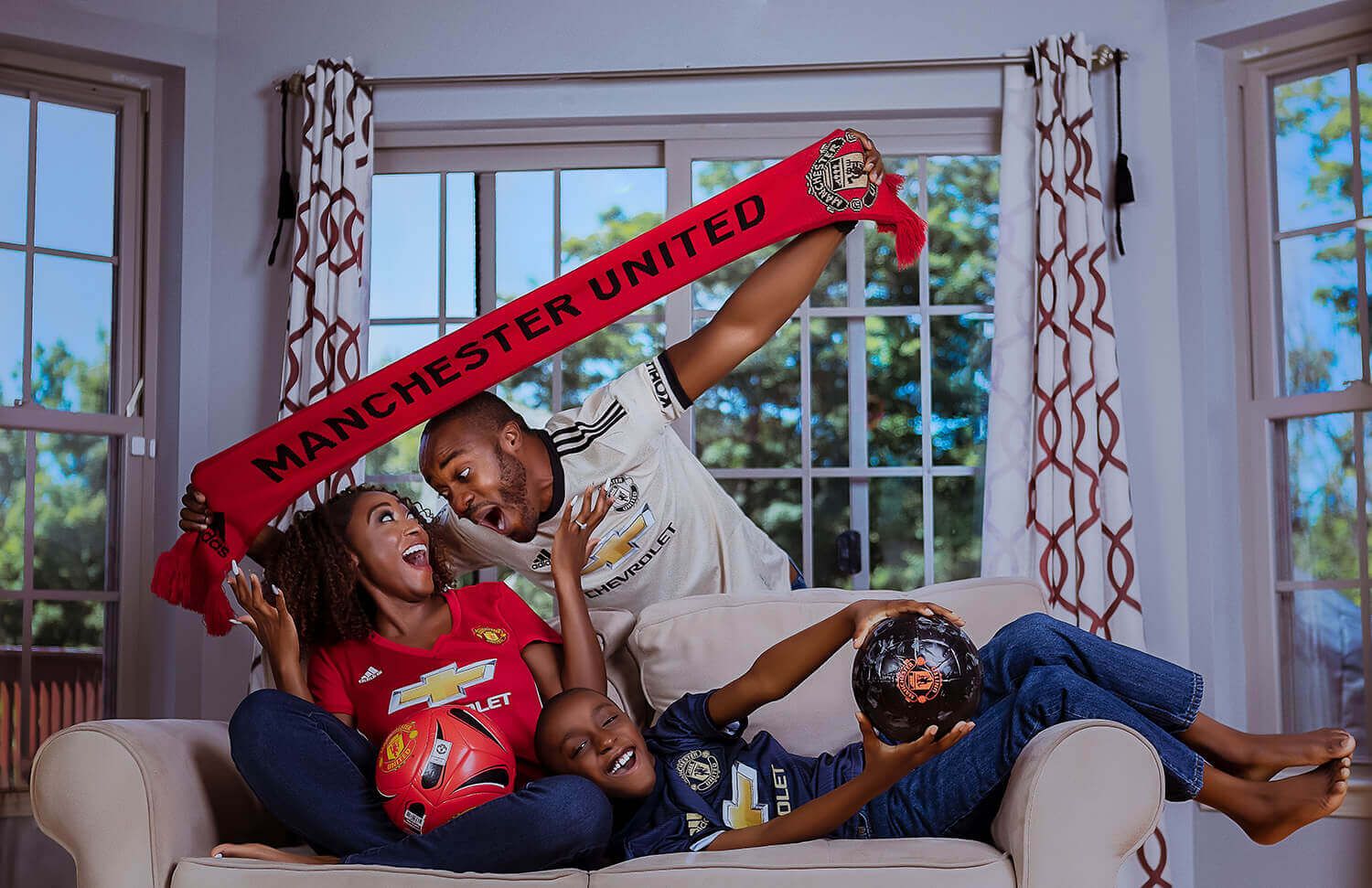 Family photo sequence on a couch showing playful moments with holiday decorations.