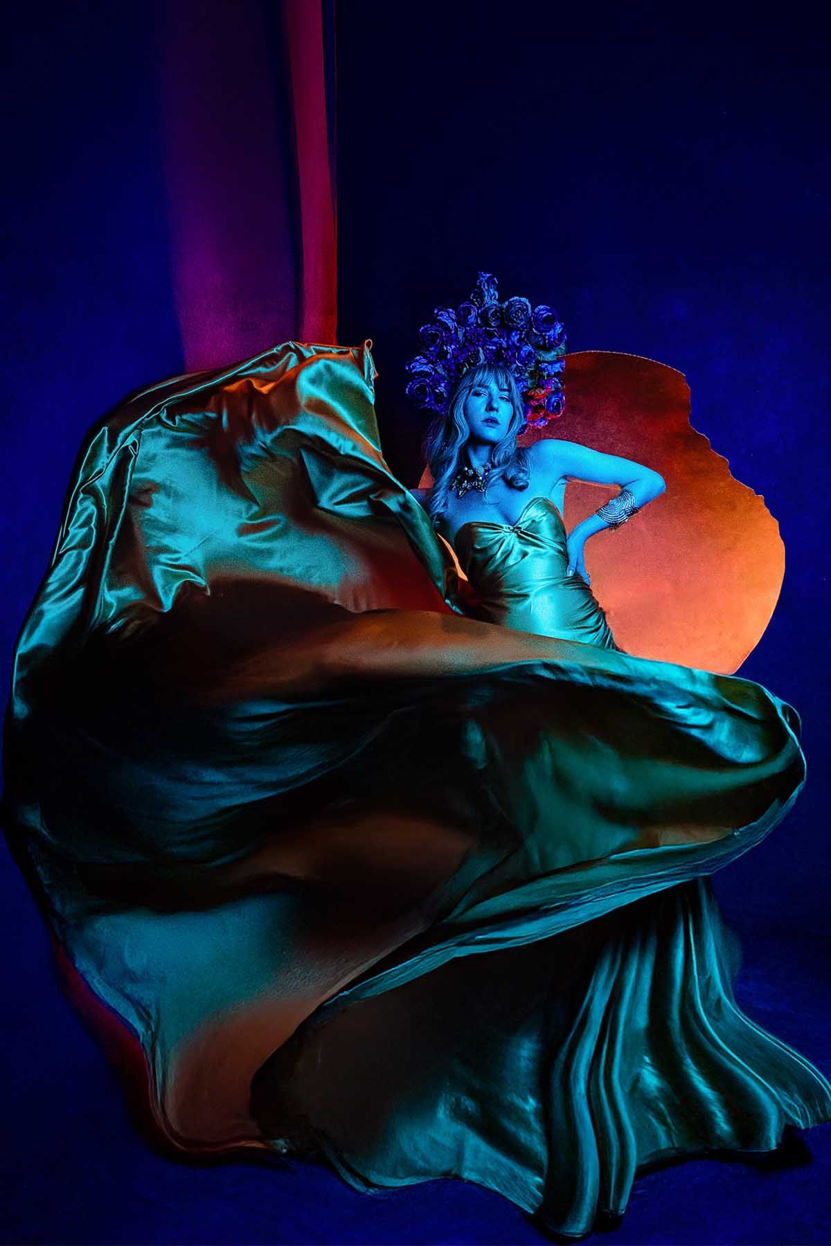 Artistic sequence of flowing fabric in blue and orange lighting creating dramatic shapes.
