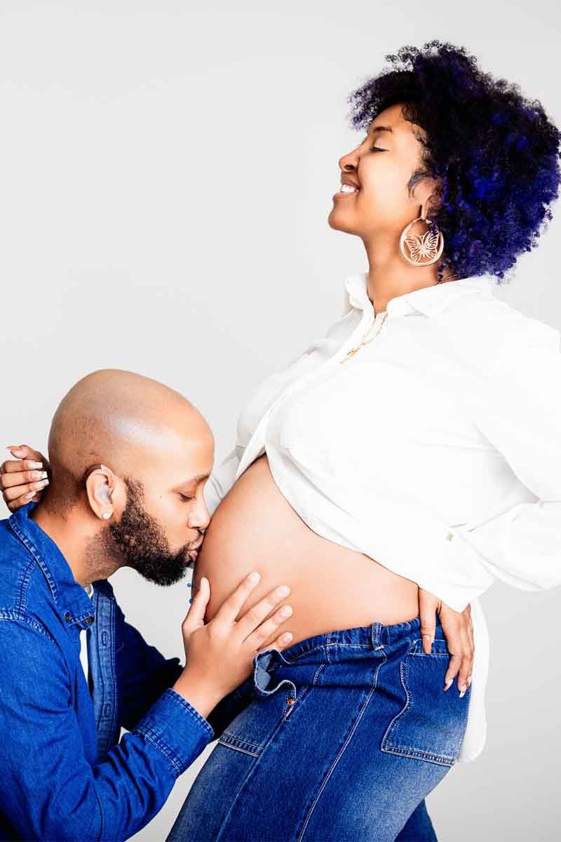 A series of intimate maternity photos showing a couple in denim and white against a light background.