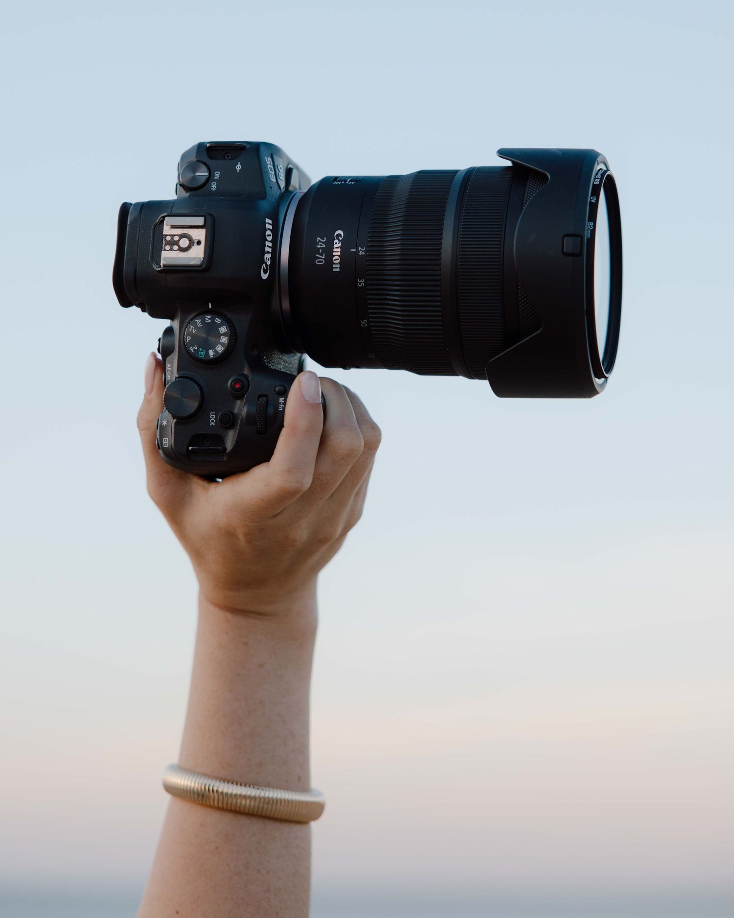 trouwfotograaf houd camera vast op het strand