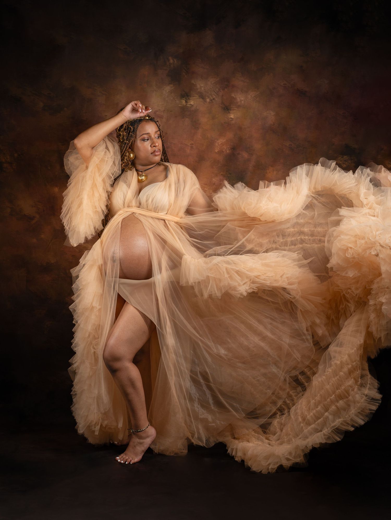 Artistic boudoir photo series with flowing beige tulle fabric against dark background.
