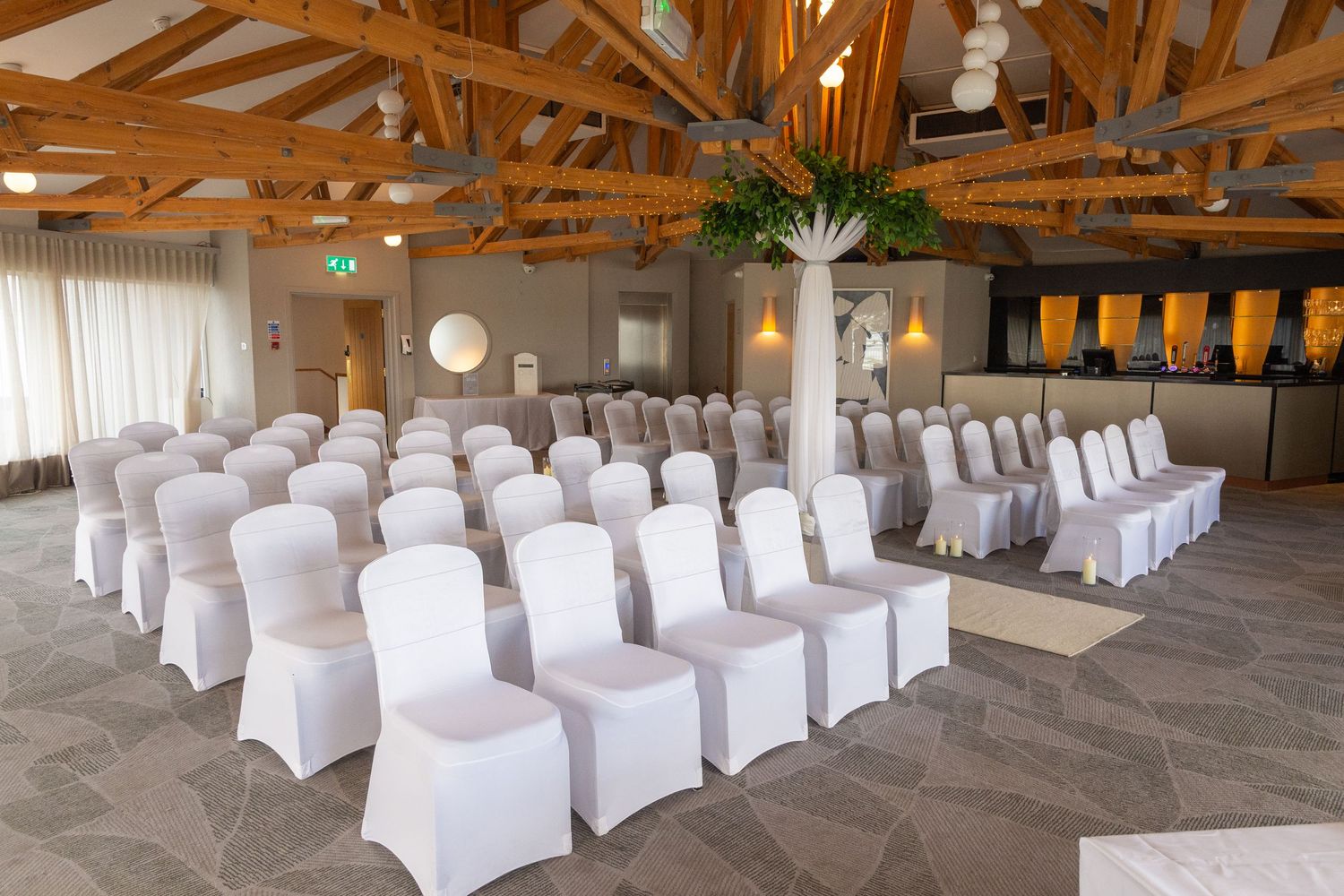 Wedding ceremony setup in the Spinnaker Suite at Langstone Quays Resort with natural light and coastal views.