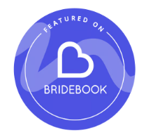 Blue circular Bridebook badge with a heart logo and 'Featured On' text for wedding vendor recognition.