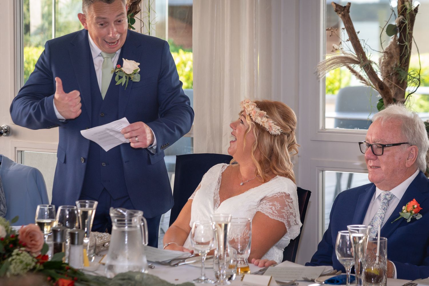 Wedding reception portraits at Harbour Hotel with lively speeches and celebrations at an elegant dining table.