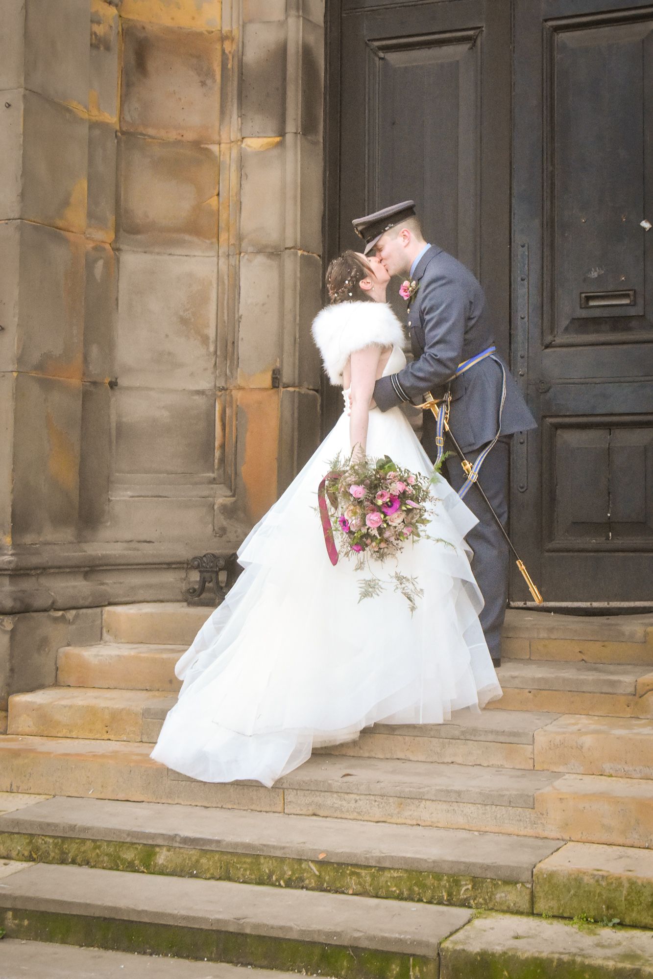 A romantic wedding sequence shows a couple in formal attire sharing tender moments on stone church steps.