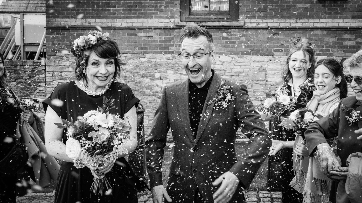 A black and white photo collage showing wedding celebration moments with guests throwing confetti and flowers.