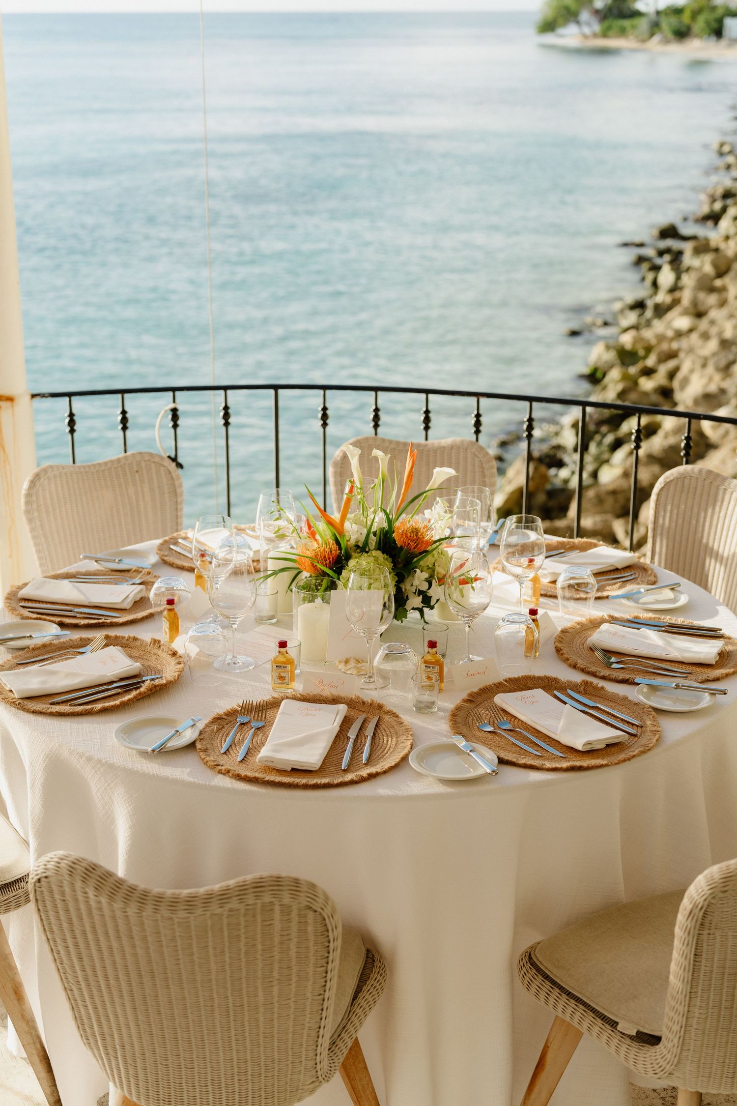 Elegant outdoor wedding reception table set with tropical flowers at QP Bistro. Barbados Destination Wedding Photograph