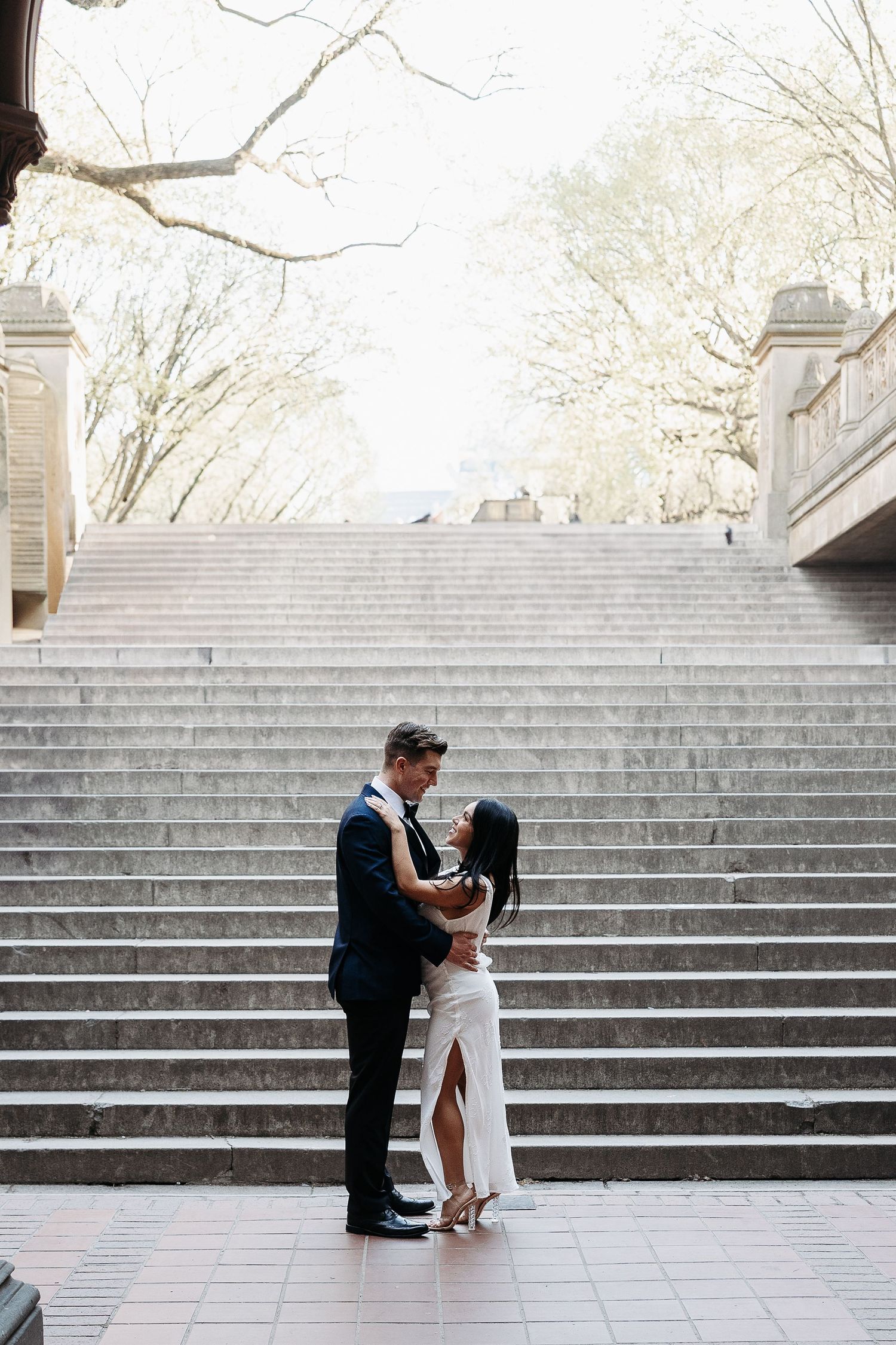 Elegant couple dancing at base of grand stone staircase in  Central Park New York City. | Karina Thomson Photography Raleigh NC