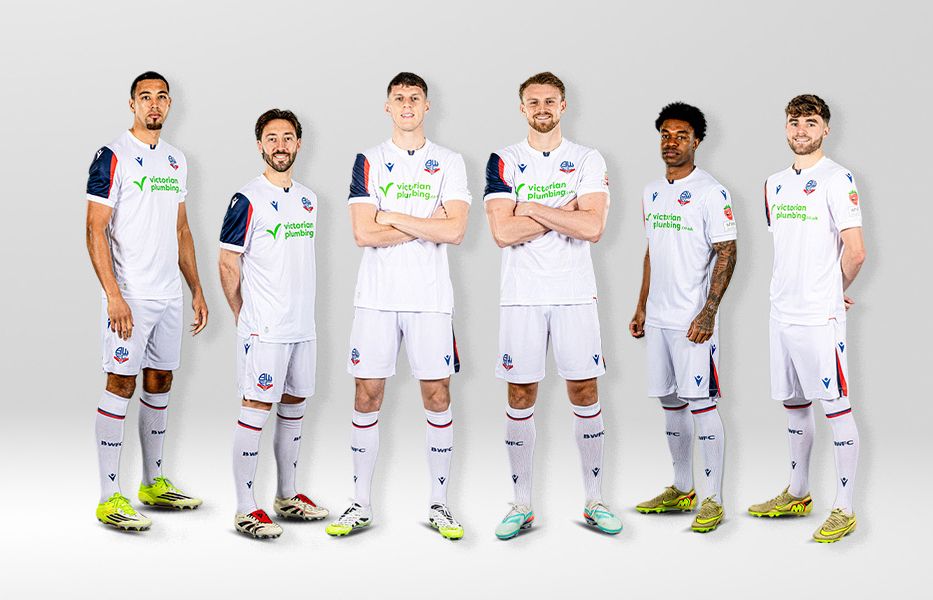 The football team squad posed together for a formal group photo against a bright white background.