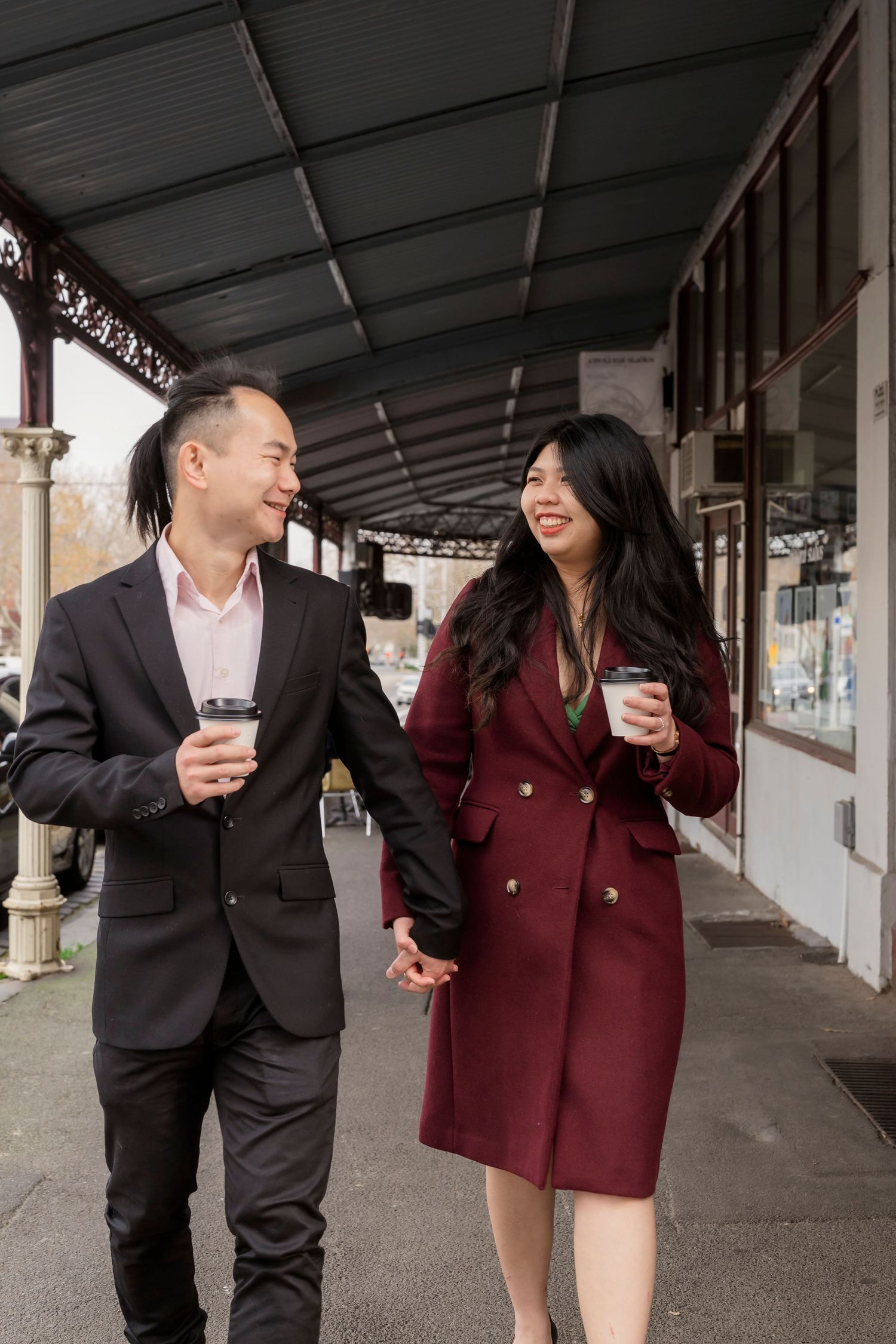 Couple wandering through the streets of Fitzroy during their Melbourne engagement session.