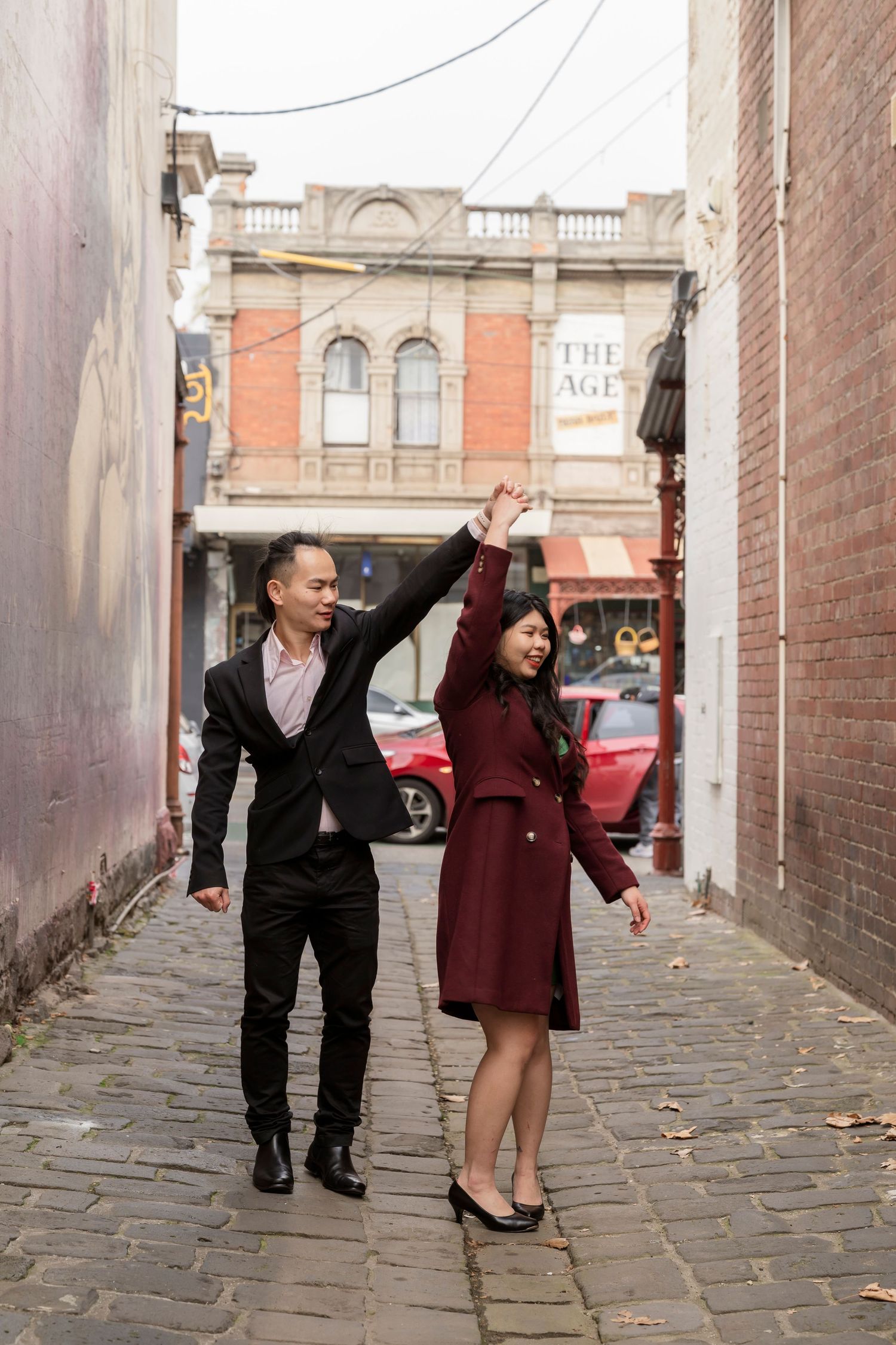 Couple wandering through the streets of Fitzroy during their Melbourne engagement session.