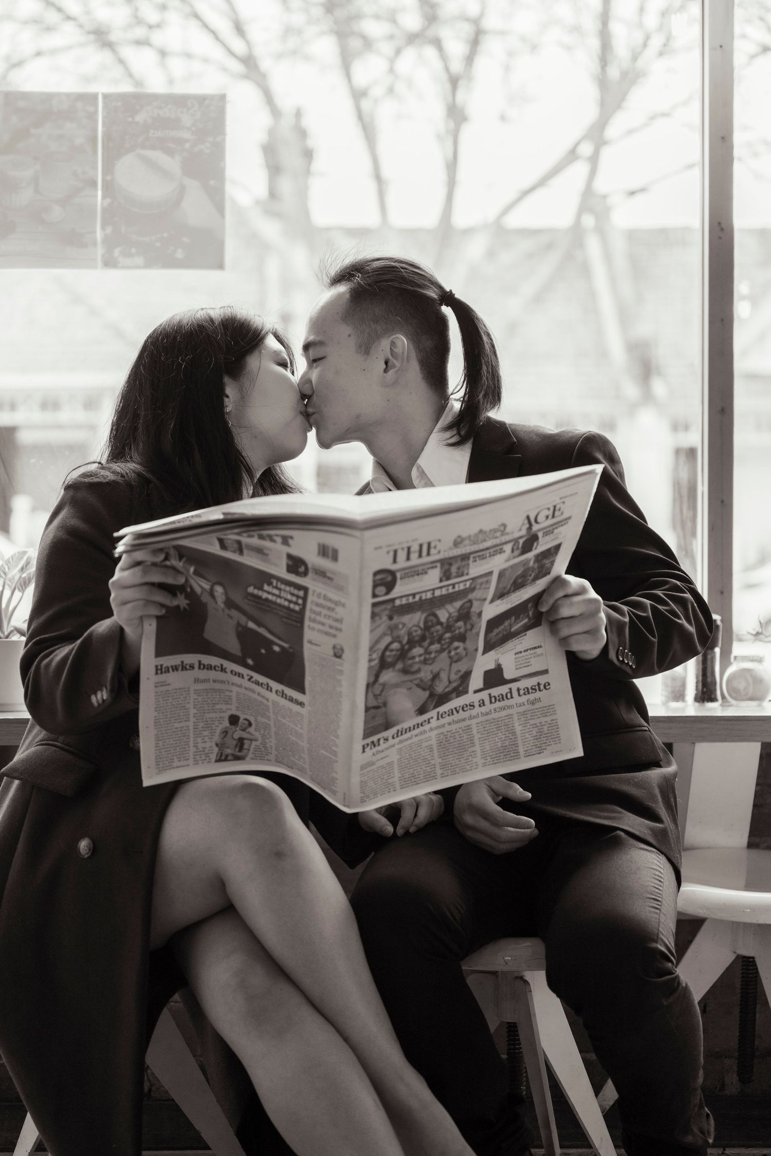 Couple sharing a coffee at a Melbourne café during their engagement photos.