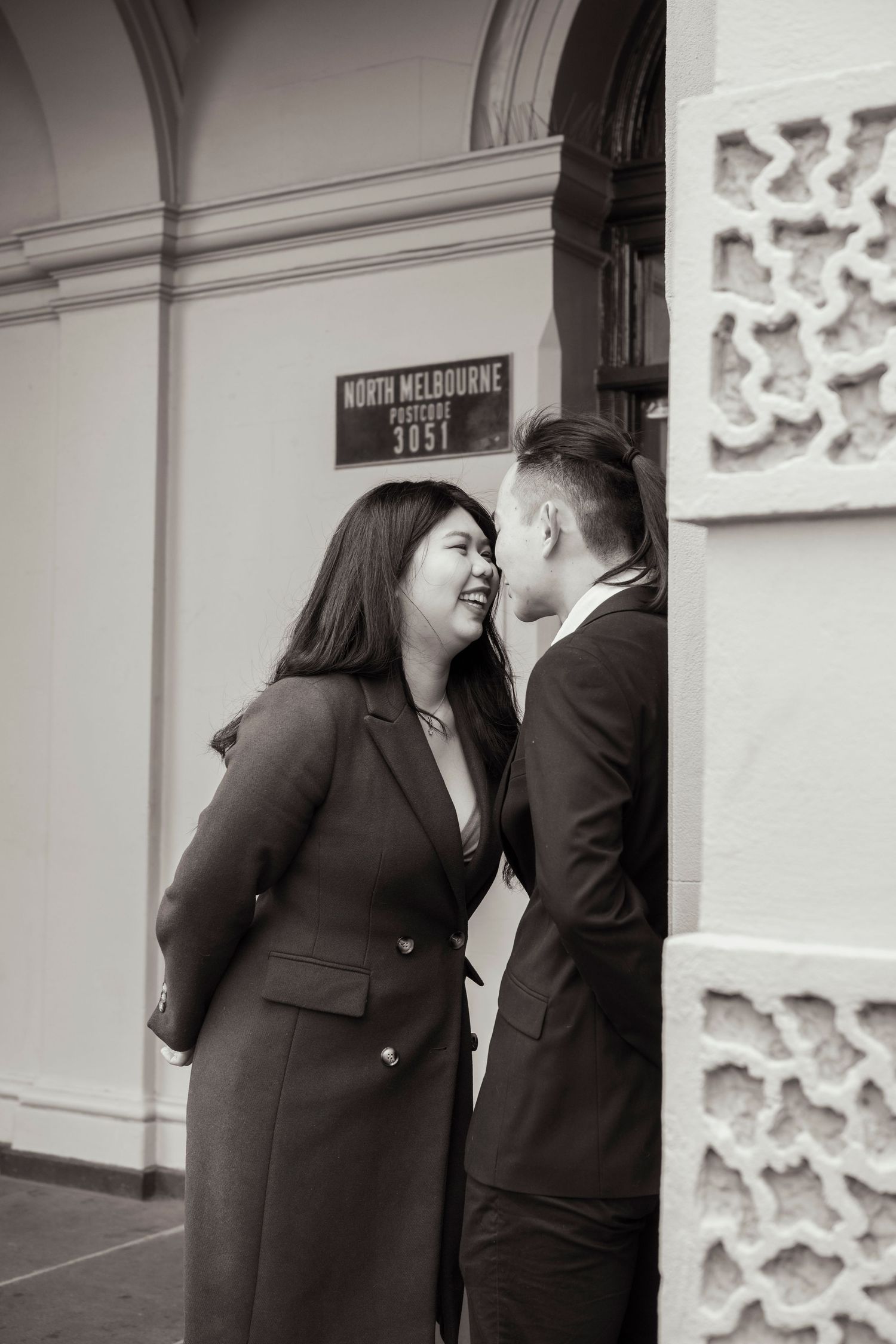 Couple wandering through the streets of Fitzroy during their Melbourne engagement session.