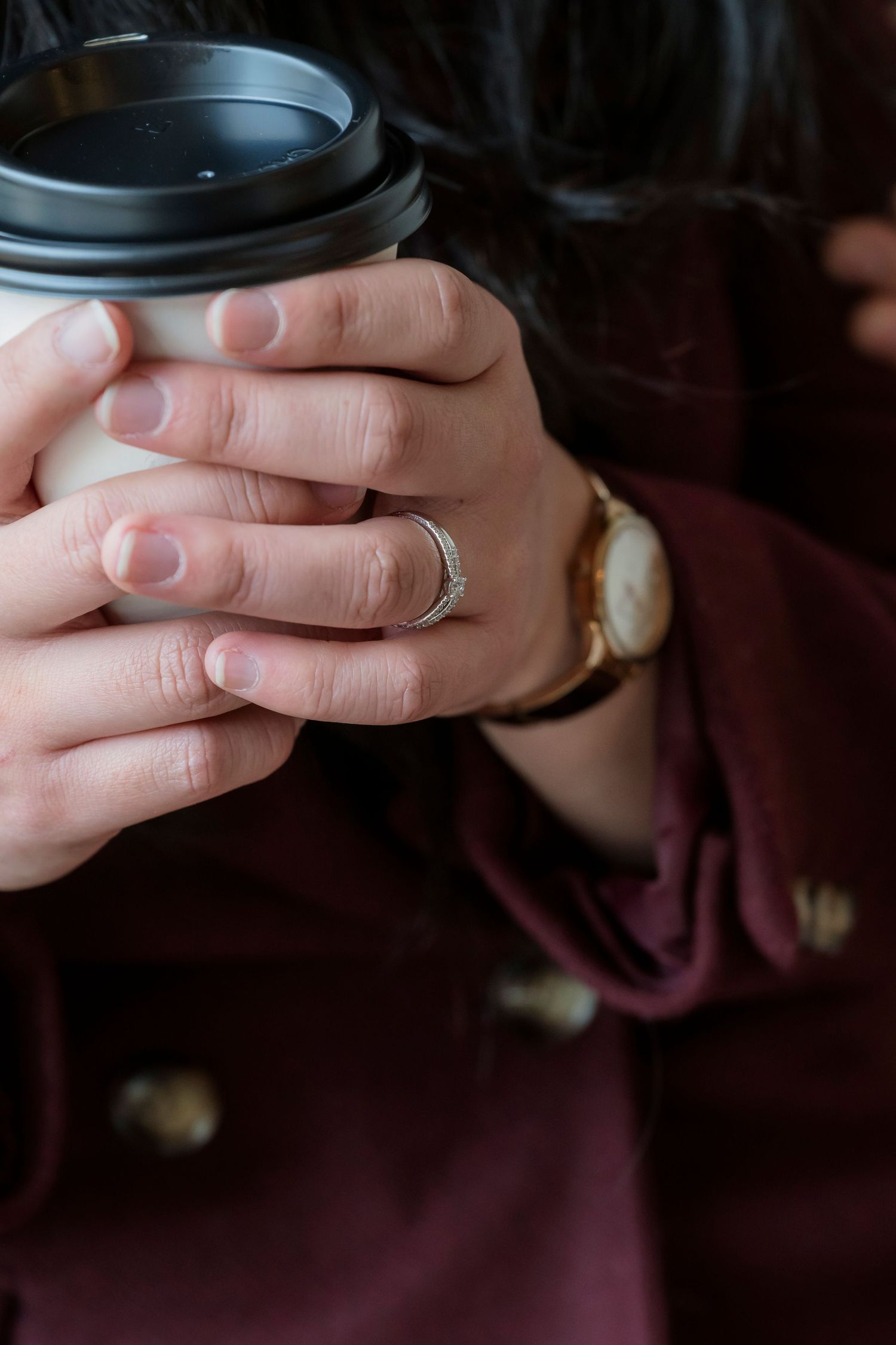 Couple sharing a coffee at a Melbourne café during their engagement photos.