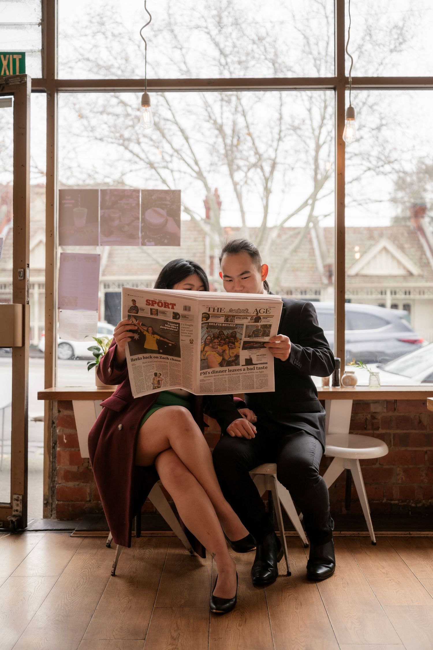 Couple sharing a coffee at a Melbourne café during their engagement photos.