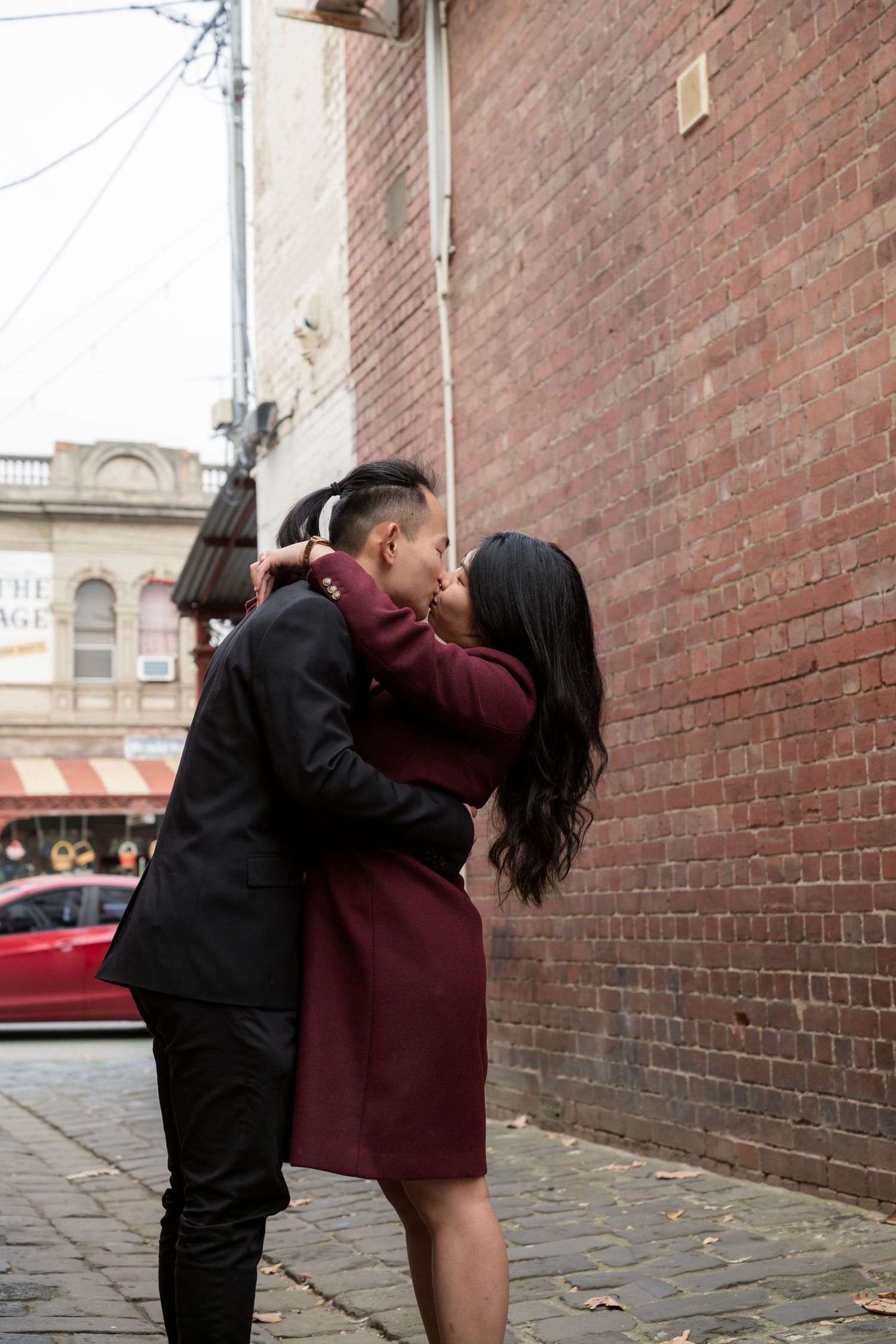 Couple wandering through the streets of Fitzroy during their Melbourne engagement session.