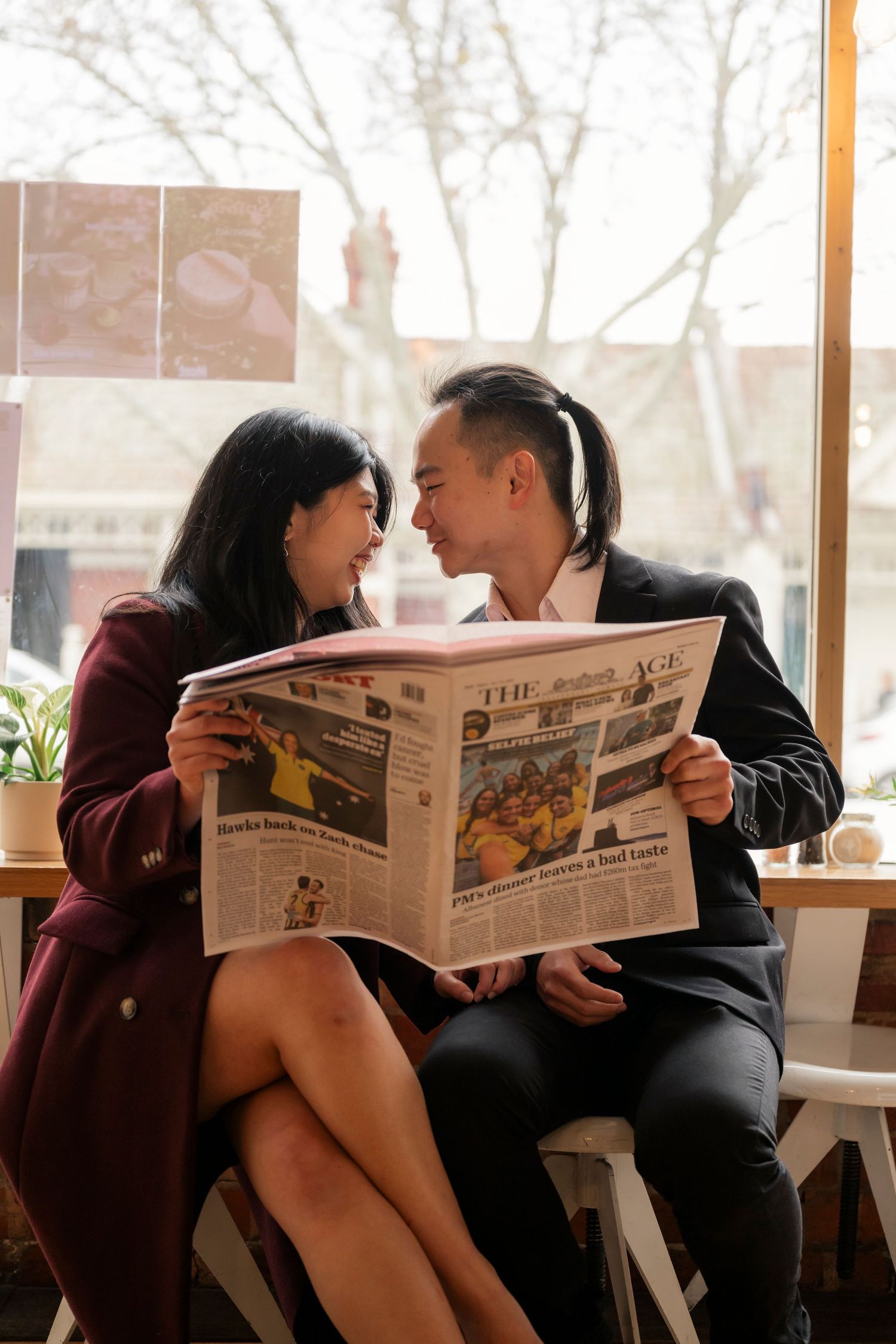 Couple sharing a coffee at a Melbourne café during their engagement photos.