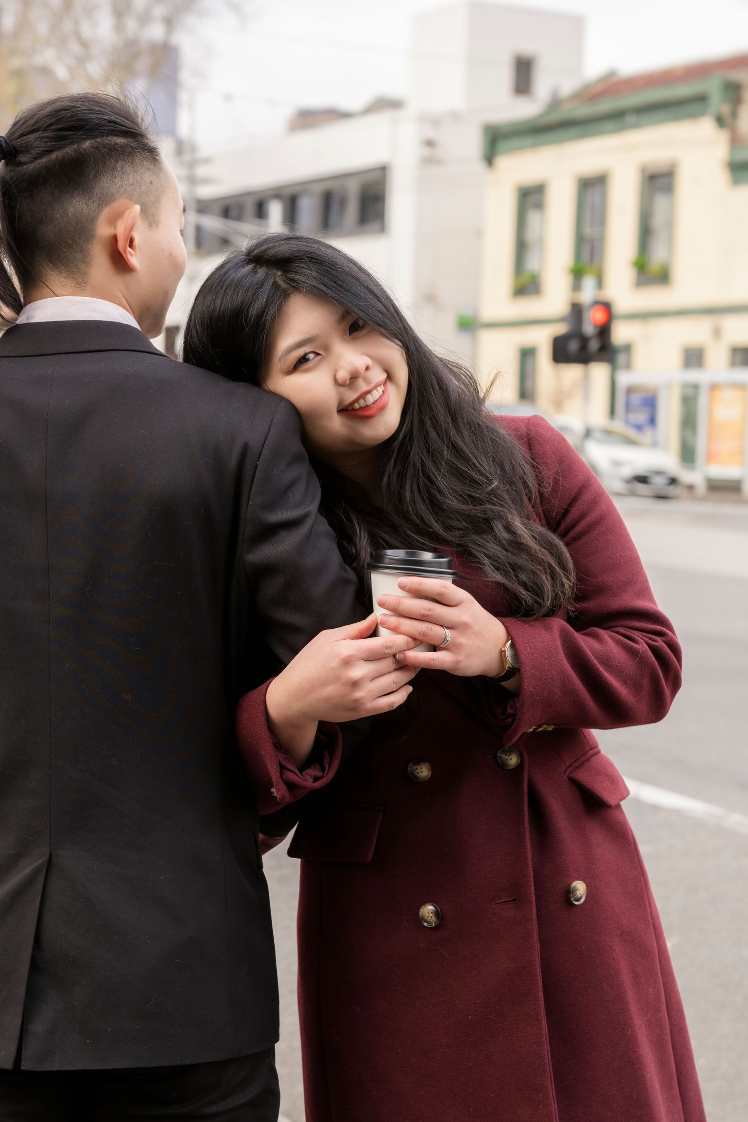 Couple sharing a coffee at a Melbourne café during their engagement photos.