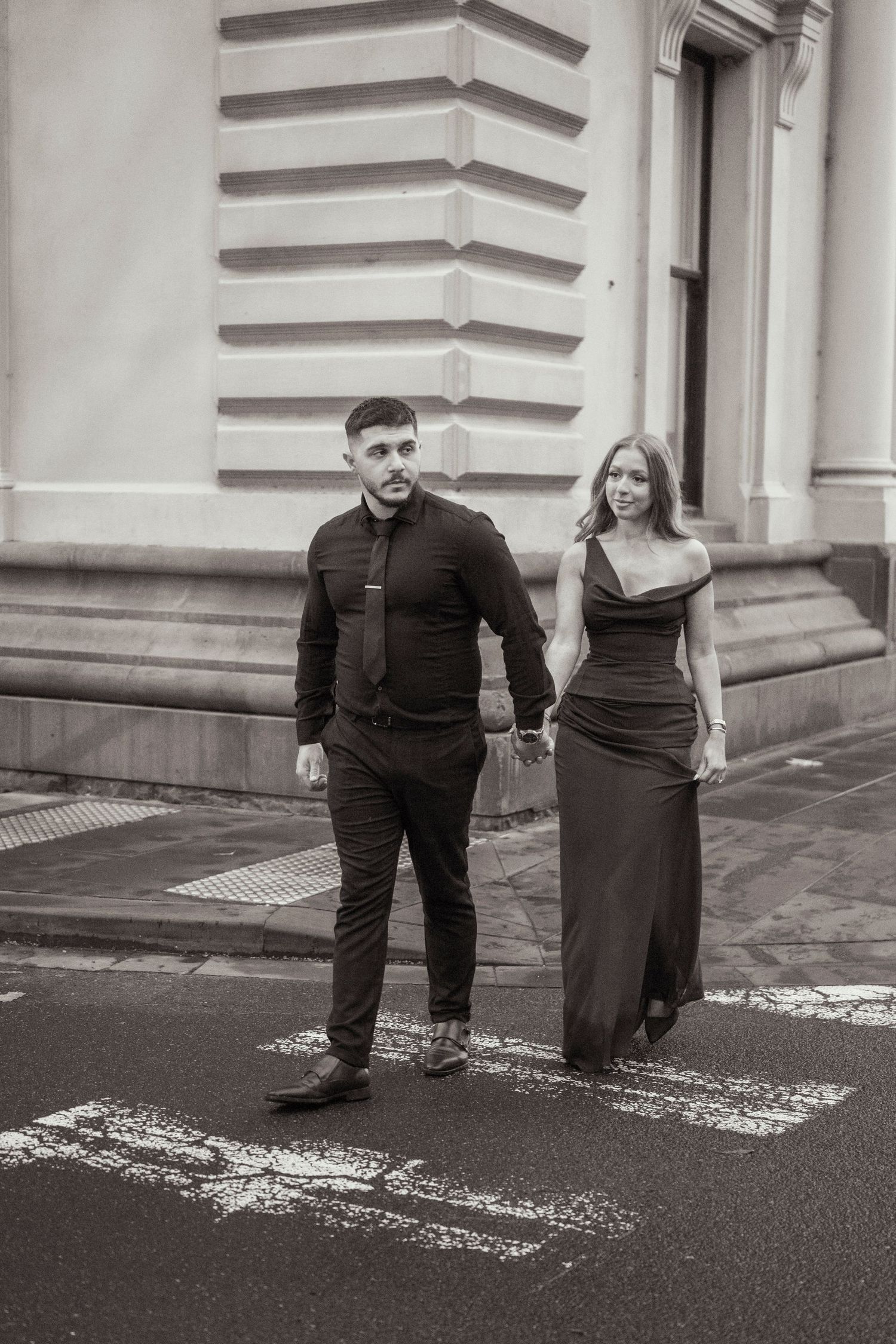 Couple wandering through Melbourne's city streets during their engagement session.