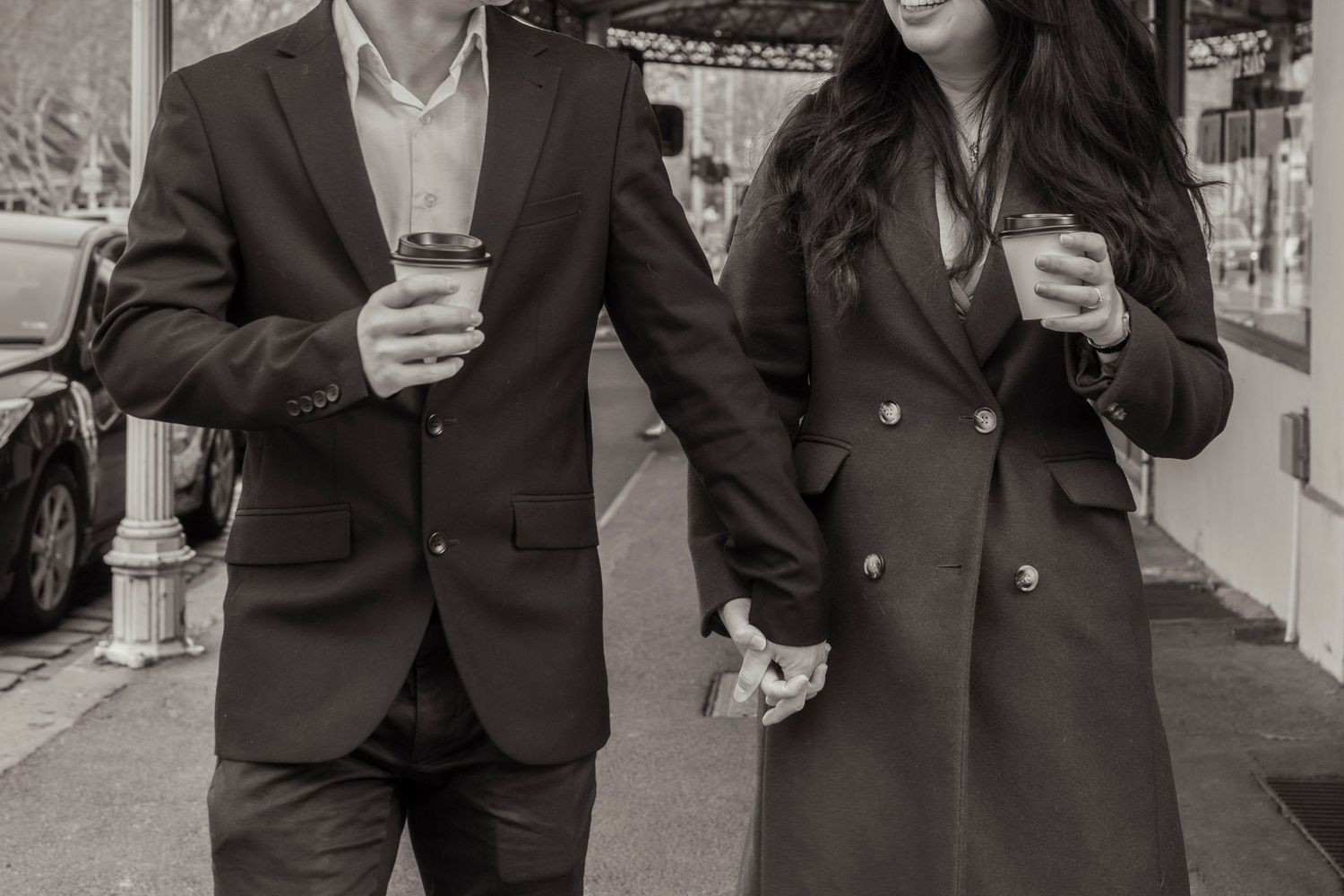 Couple sharing a coffee at a Melbourne café during their engagement photos.