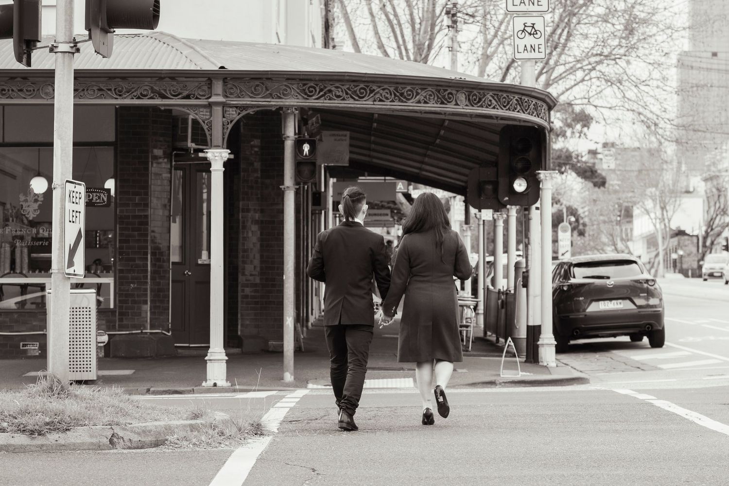 Couple wandering through the streets of Fitzroy during their Melbourne engagement session.